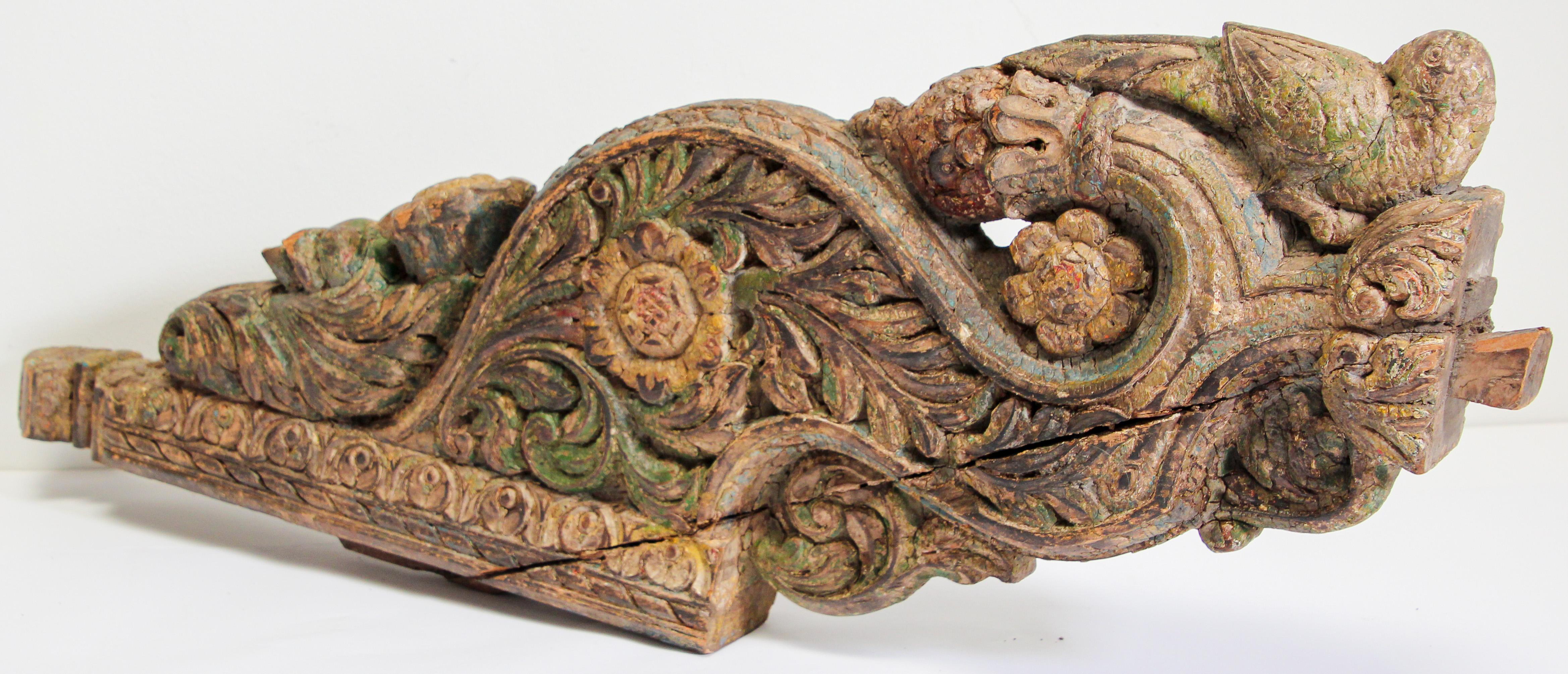 Antique architectural carved wood temple truss fragment from Rajasthan India.
Large and heavy wood hand carved fragment architectural temple fragment.
Depicting a bird, foliages and flower, used to be hand painted some green and blue colors still