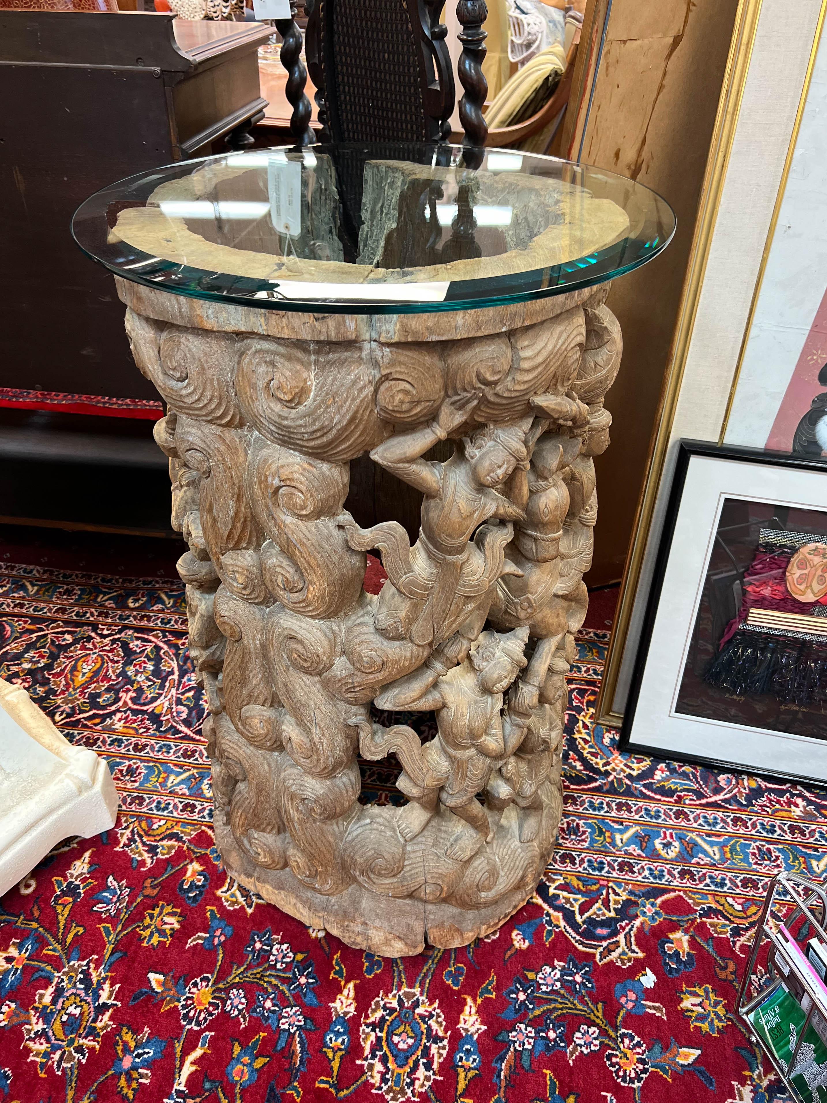 An antique Thai wood carving. Carved from a tree trunk hollowed in its center, this drum pedestal will add texture and interest to any scape. It will capture your attention with its rustic, organic appeal. A piece of art by itself or a display