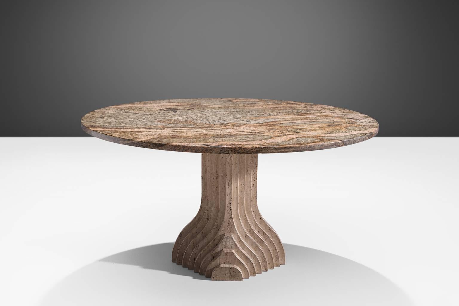 Dining table, travertine and granite, Italy, 1970s

The base of the table is formed out of a layered pillars that seem exist of several pillars in a row, clearly a reference to the architectural aesthetics of Carlo Scarpa. The circular granite top