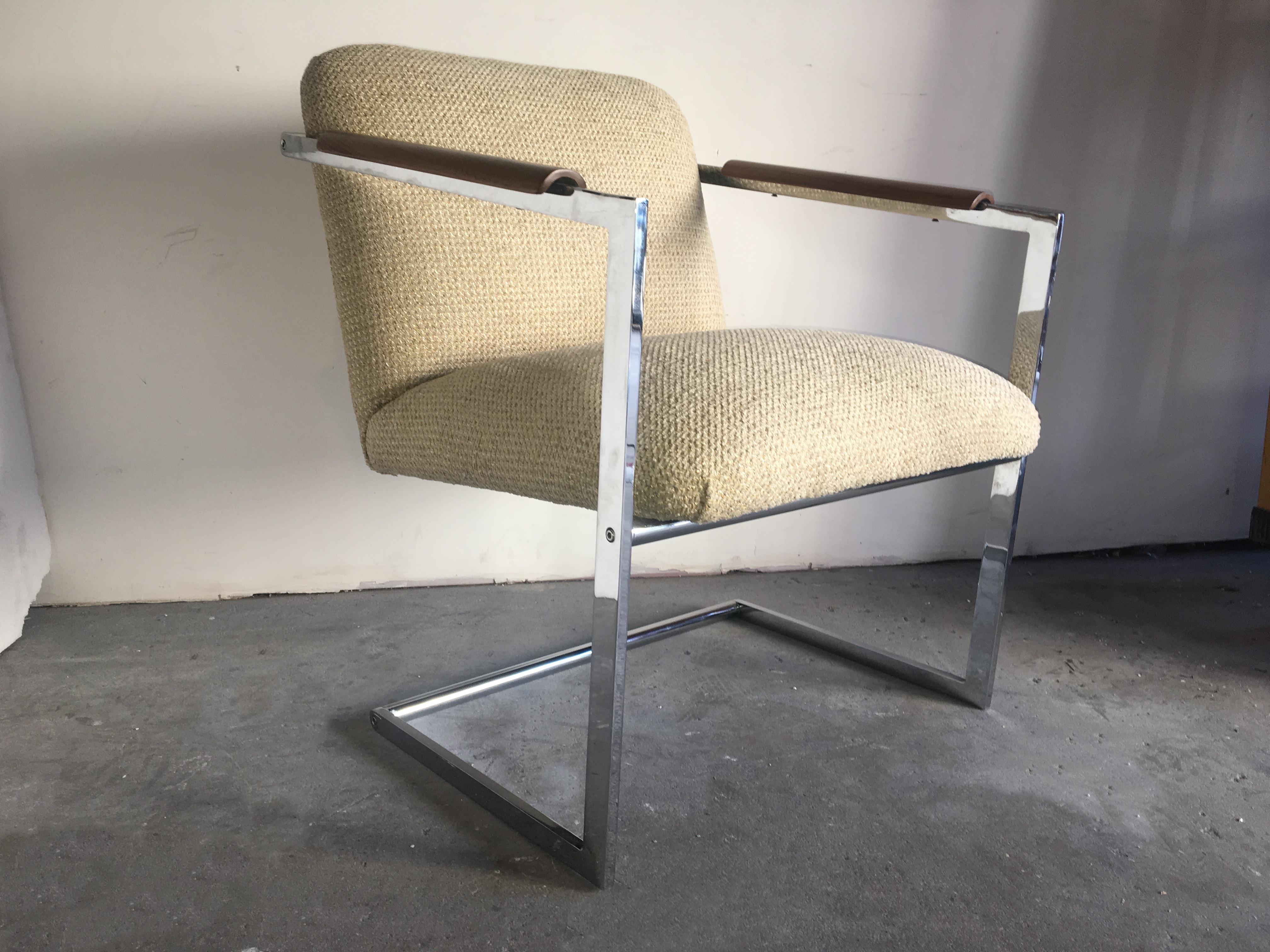 Cantilevered pair of chrome visitor chairs with walnut armrests in the manner of Milo Baughman.