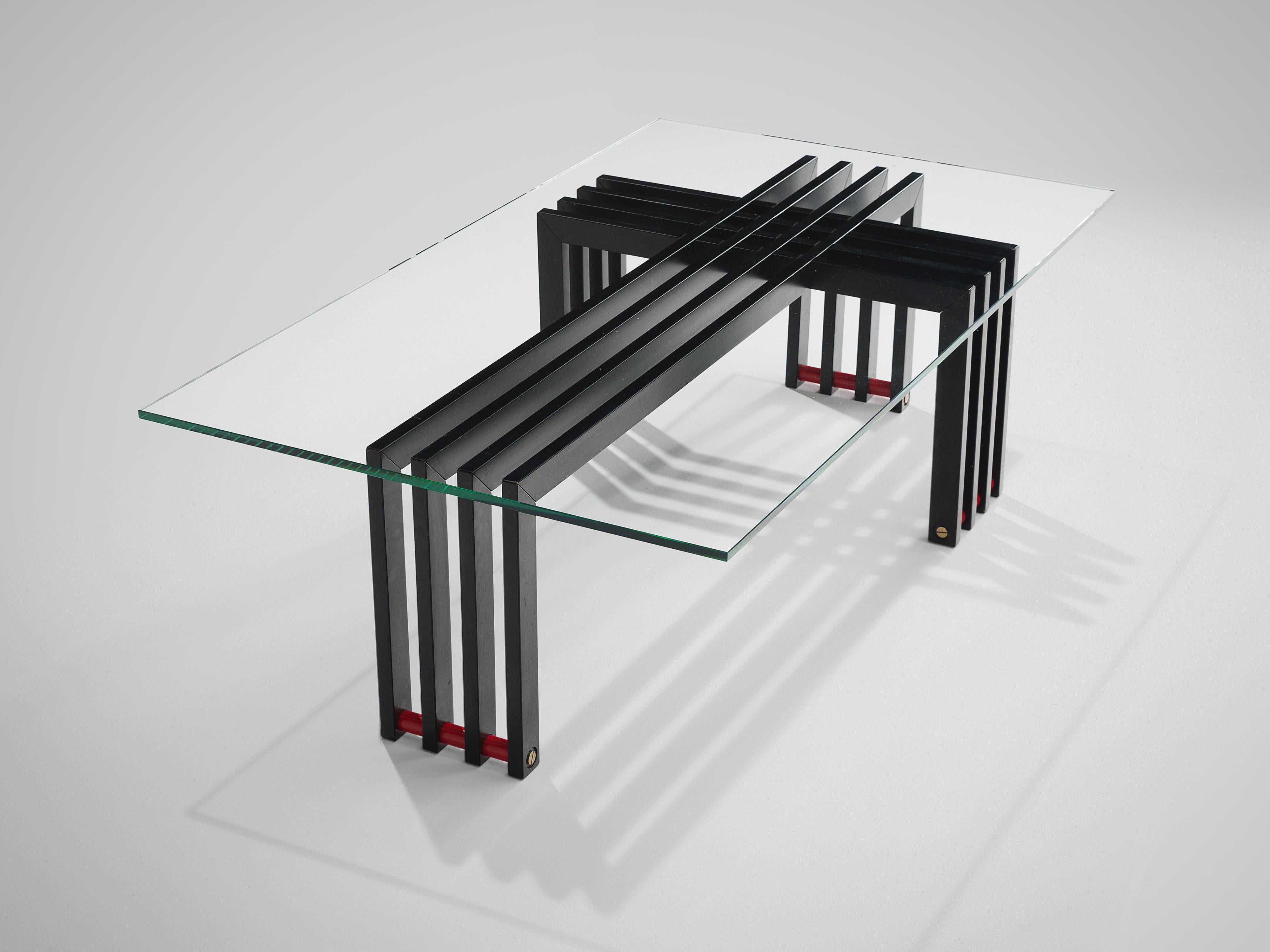Coffee table, glass, steel, Europe, 1970s.

This sculptural coffee table embodies a transparent glass top and geometric frame and horizontal red slats as a foot. Four curved iron slats form a cross with another four slats of metal. This sculptural