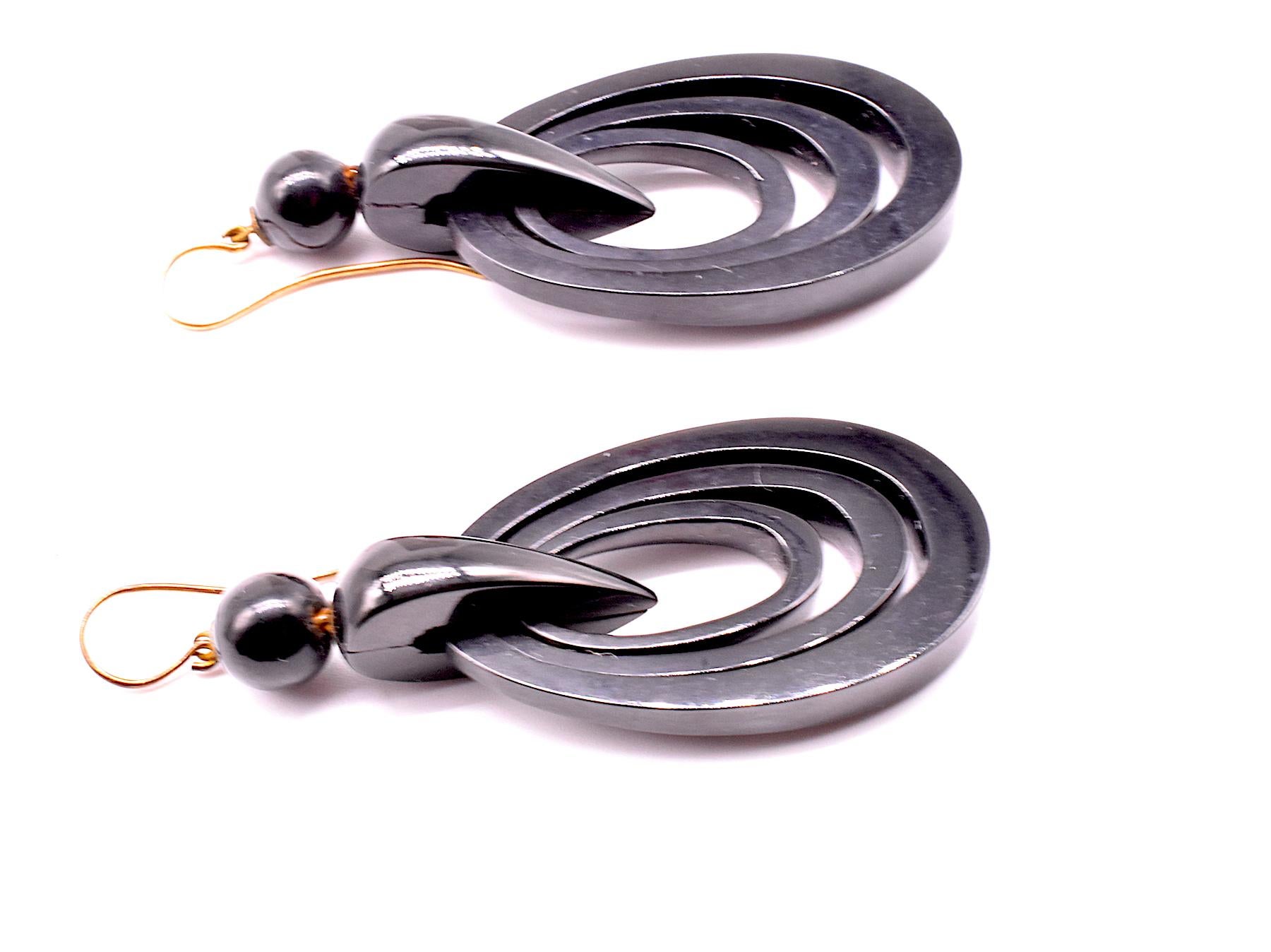 Wonderfully modern form geometric concentric circle earrings with three concentric circles inlaid within a larger circle. The earrings are mounted on shepherds hooks for uncomplicated administration and removal. While the earrings are almost 2.5