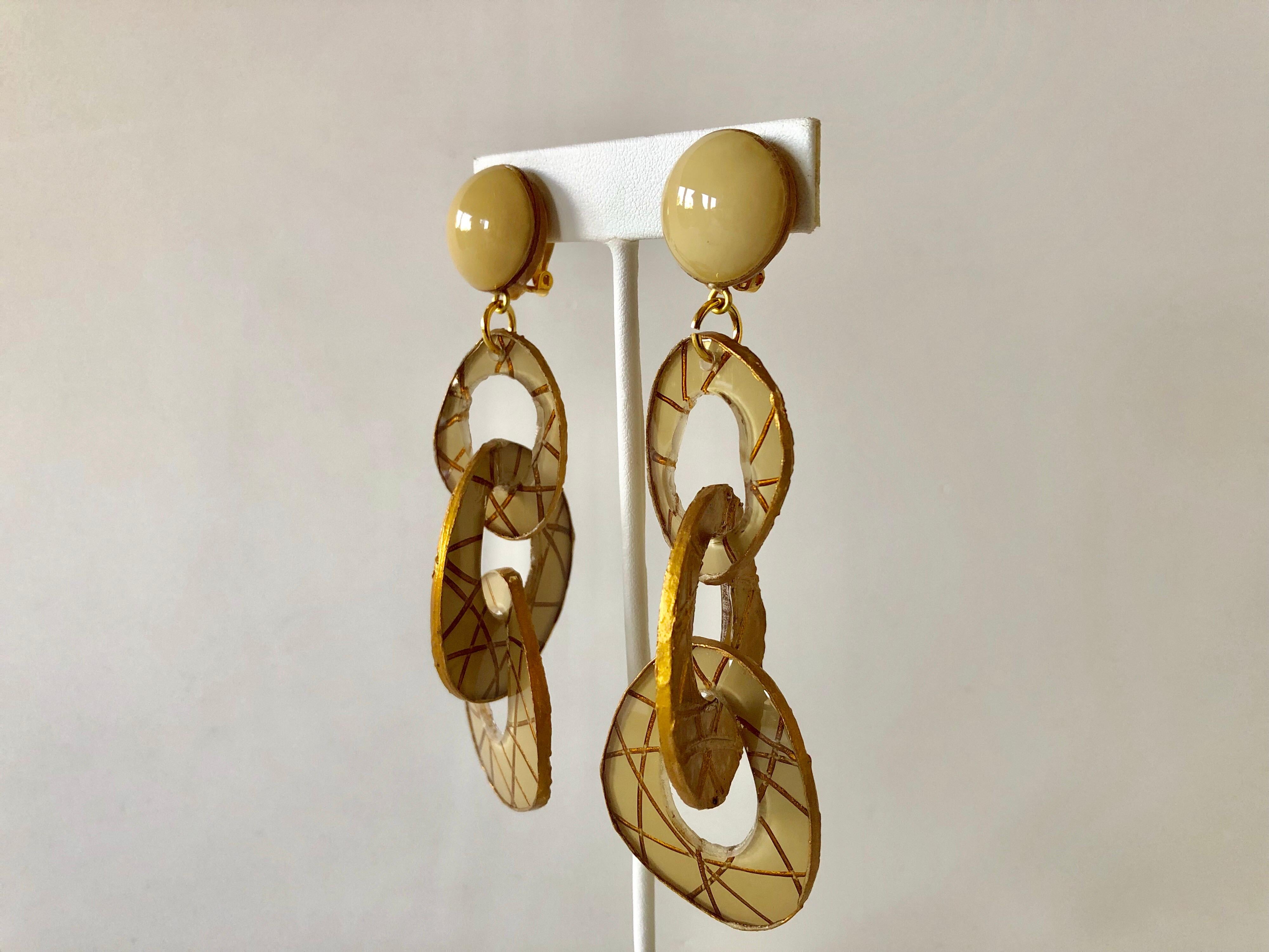 Chic and  very current, these handmade fashion forward artisanal clip-on earrings were made in Paris. The statement earrings feature three carved detailed architectural  (enamel and resin composite) geometric links in taupe and gold. Lightweight and