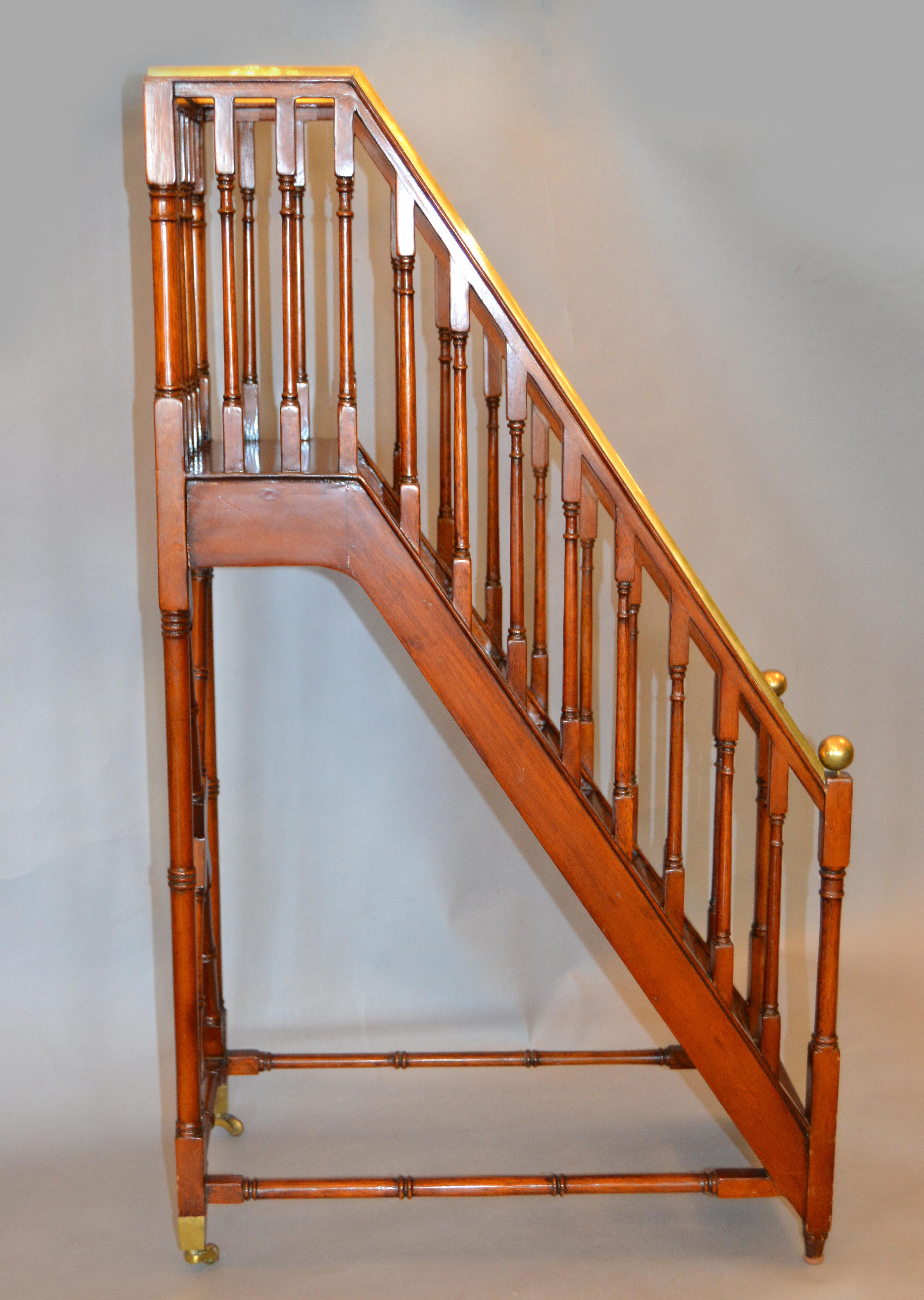 Traditional architectural decorative in walnut and brass library steps, ladder or stairs.
A very delicate quality handmade Walnut ladder with brass details.
The wheels to the front are an elegant and practical accessory.
         