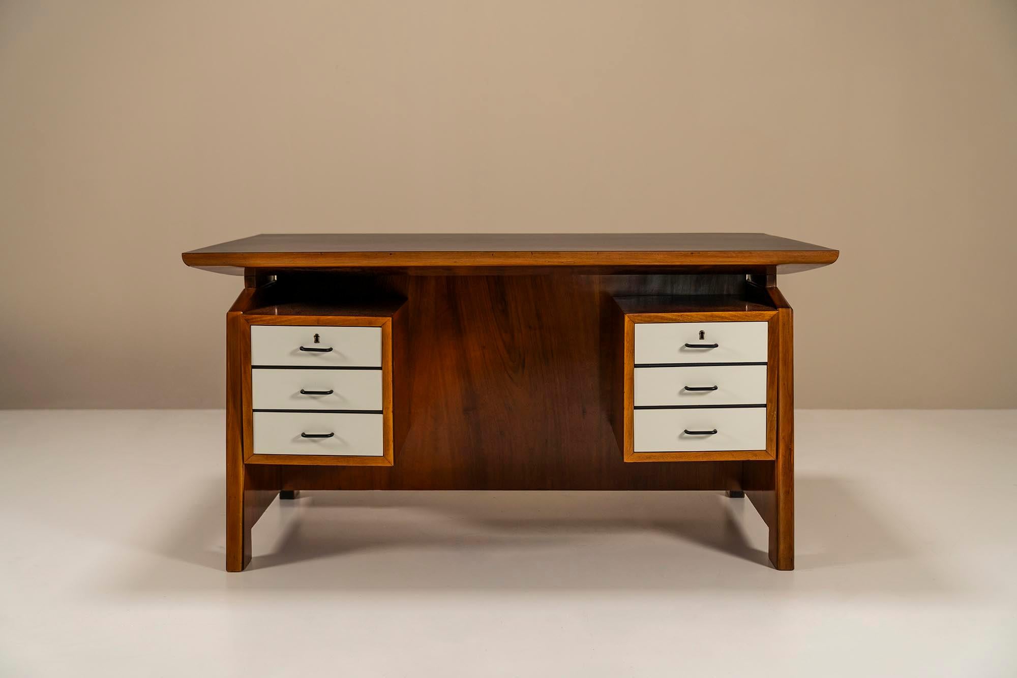 Architectural Desk in walnut by Carlo De Carli.This desk has a very solid and a kind of determined look with the unmistakable charm of the Italian design of the fifties. According to tradition, this is a design by the Italian master Carlo De Carli.