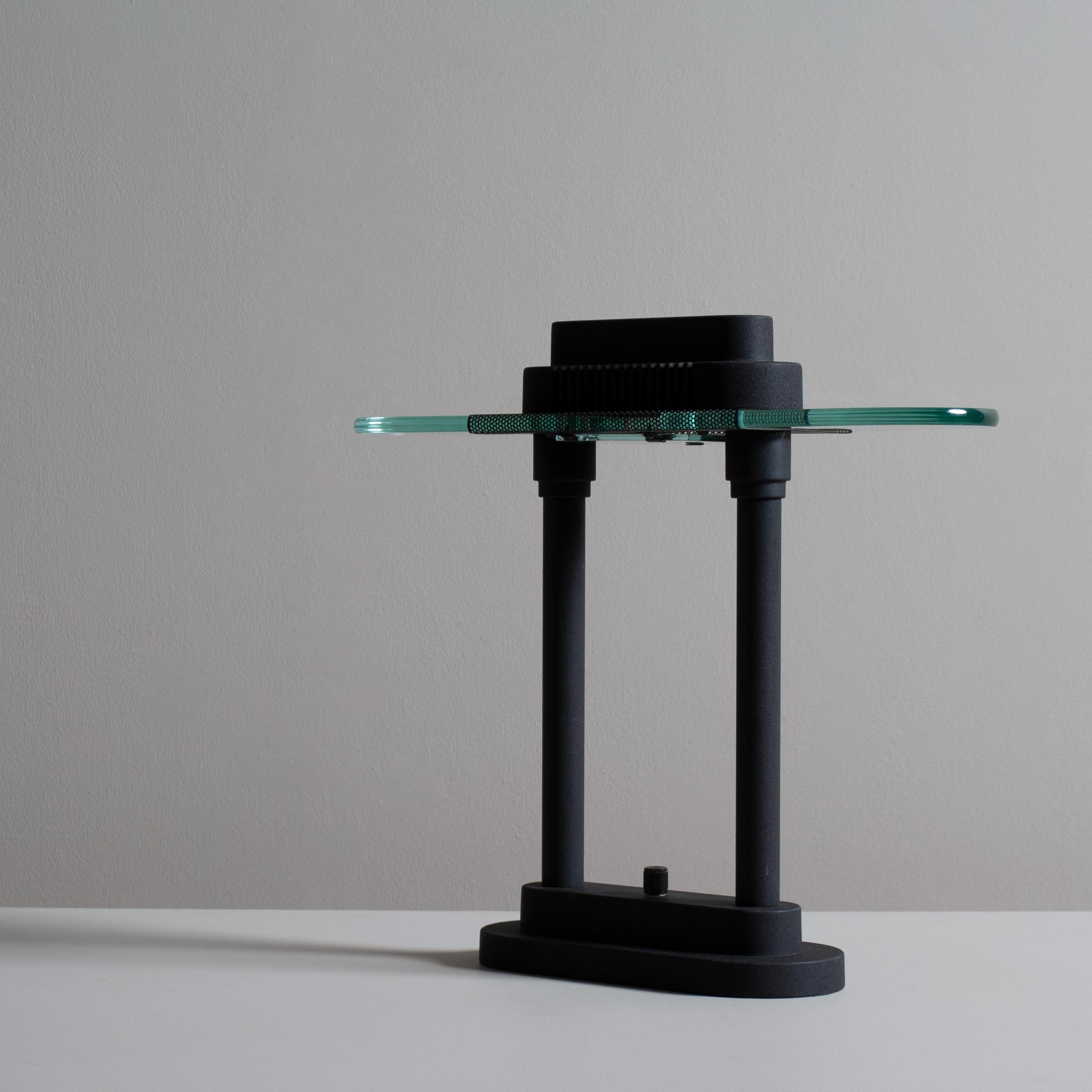 A lovely example of Robert Sonneman Memphis design table/desk lamp. Matte black finish with thick glass top diffuser. Dimmable switch. Wonderful architectural design.