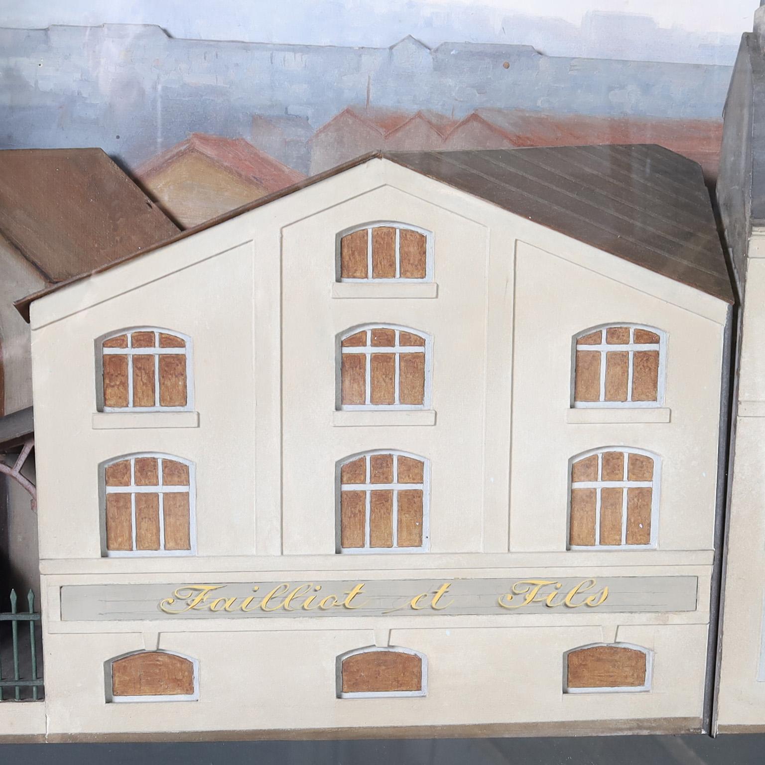 Rare and unusual antique diorama of a street in a neighborhood, in a city capturing a time and a place for centuries to come. Crafted with metal and paper painted with striking accuracy. Presented in a mahogany frame under glass and signed P.