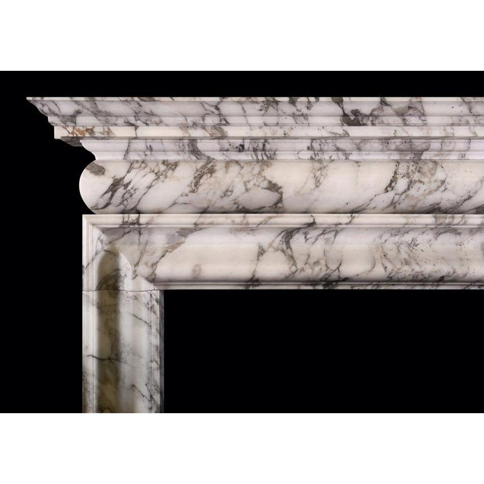 An architectural fireplace in the Georgian manner. The inner bolection moulding surmounted by barrel frieze and moulded shelf above. Shown in Italian Arabescato marble but could be made in other marbles or limestones if required. English, modern.