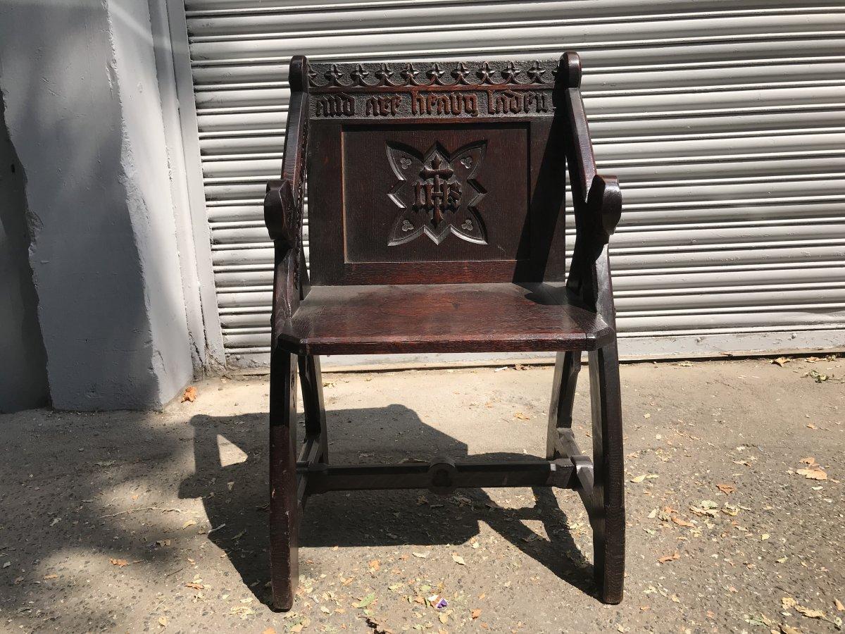 An architectural Gothic Revival oak Glastonbury armchair in the style of E W Pugin. 
A very good quality armchair, well designed, with skill full carving and a welcoming Inscription that reads: -

