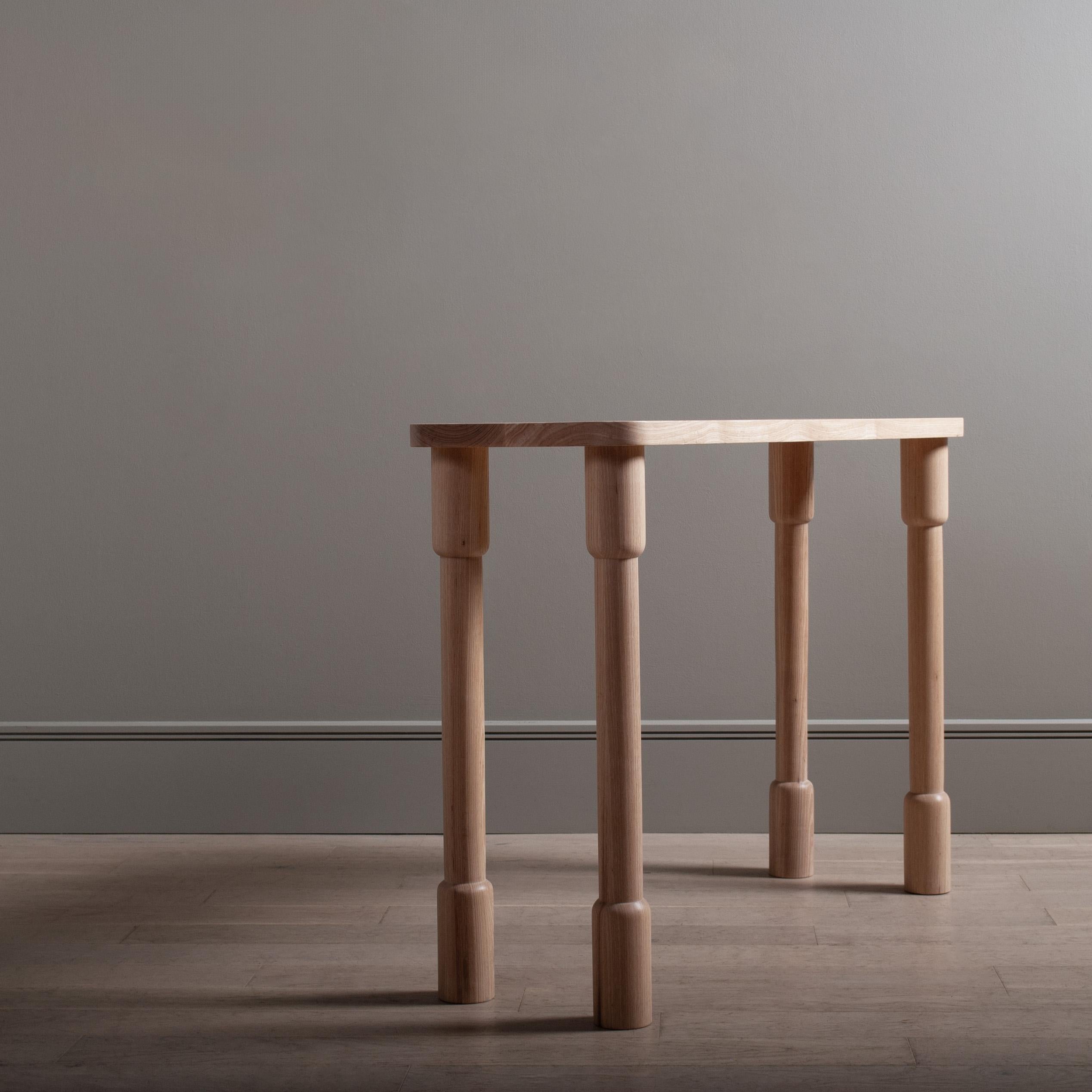 Architectural maunsell table designed and handmade in England using traditional furniture making techniques. Completely handcrafted from prime English ash. Hand-turned legs jointed through and flush to the main surface.
A solid and striking piece of