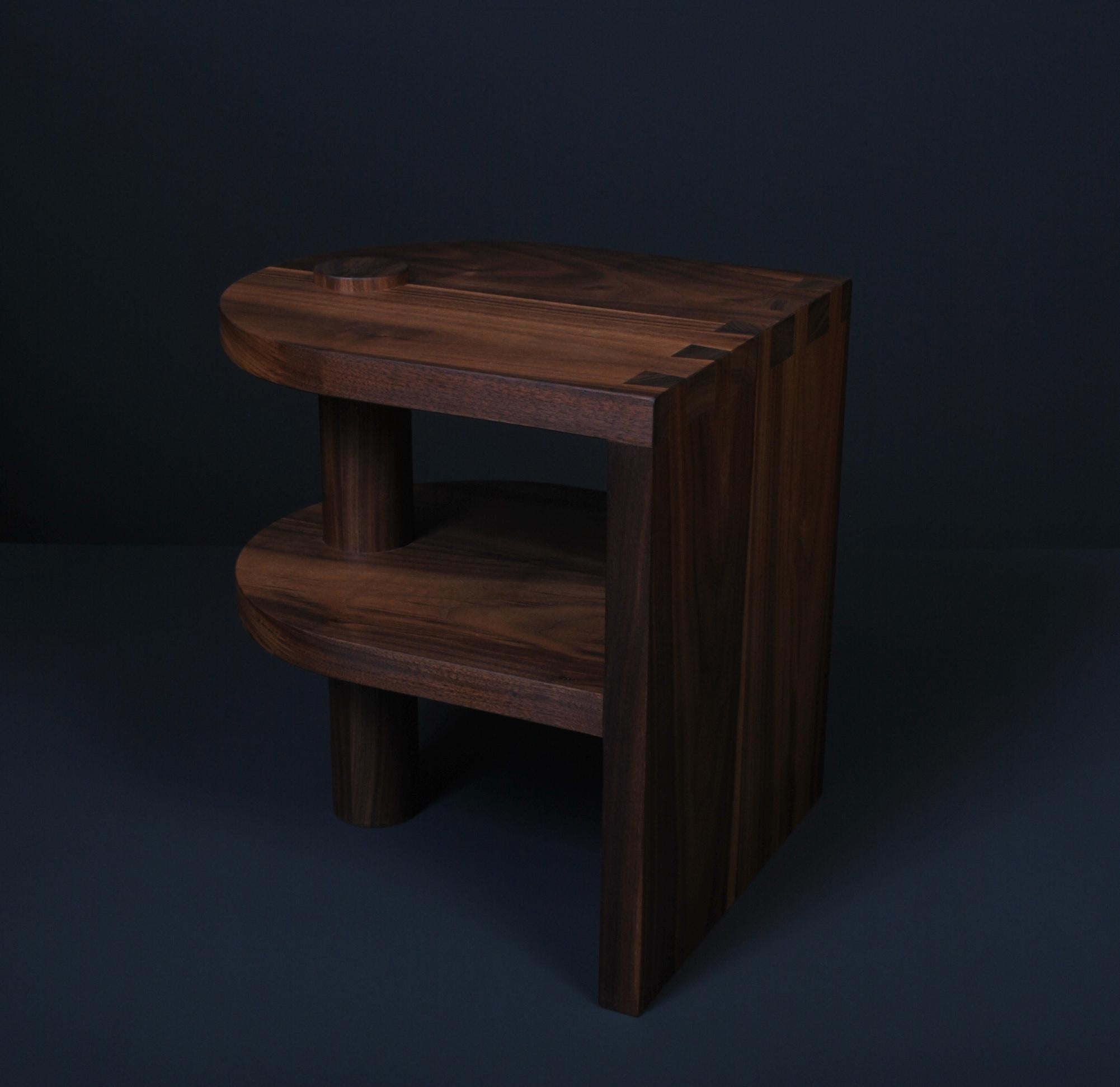 Architectural postmodern American black walnut pillar end or side table. Designed by us and handcrafted in England using traditional techniques using the finest American Black Walnut. Hand-cut large dovetail jointing details with hand - turned