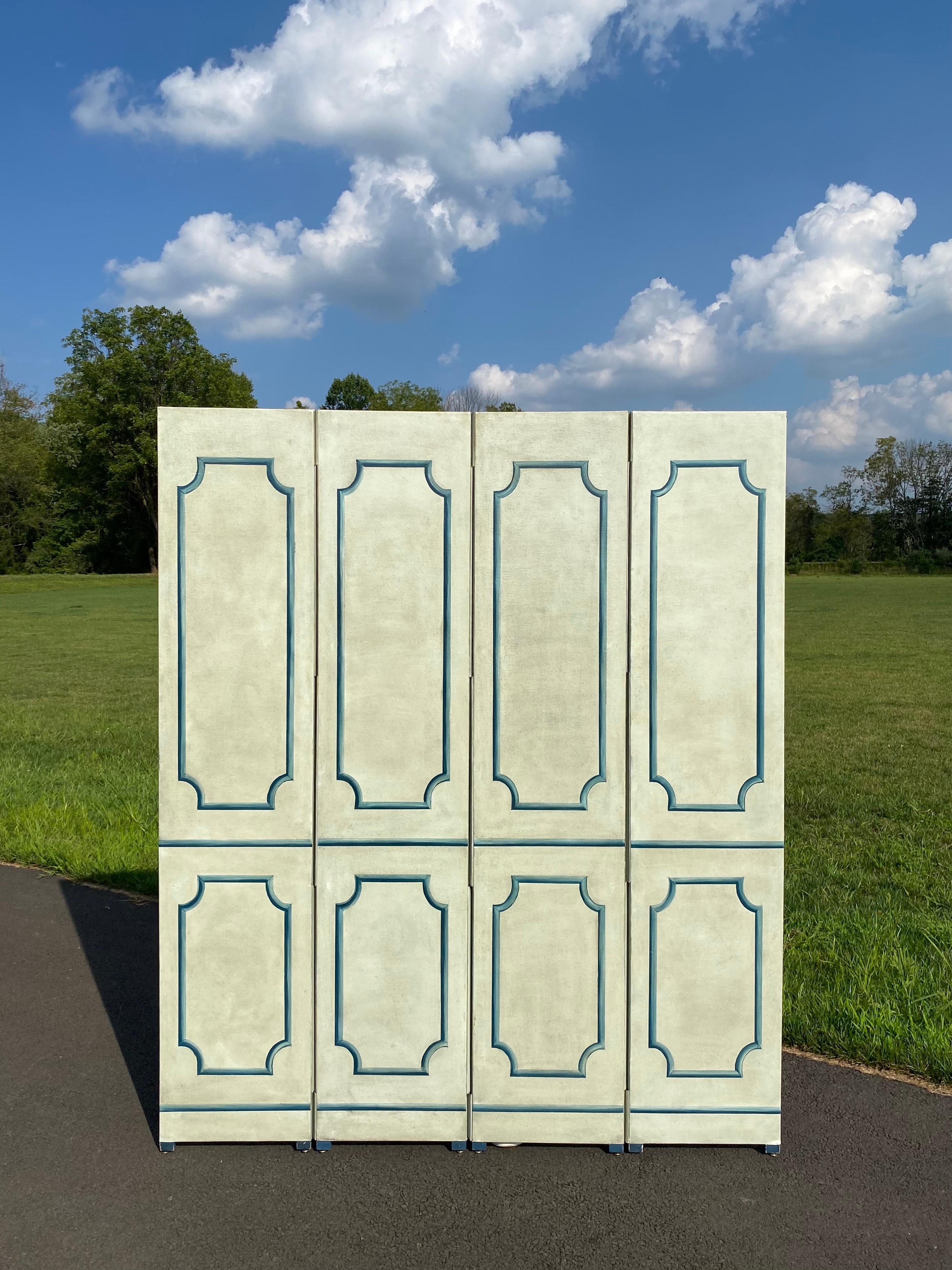 Beautiful neoclassical style four panel room divider. This tall architectural floor screen is wrapped in a textural neutral tone glazed canvas with hand painted moldings in multi shades of blue. Screen is finished on both sides with same design and