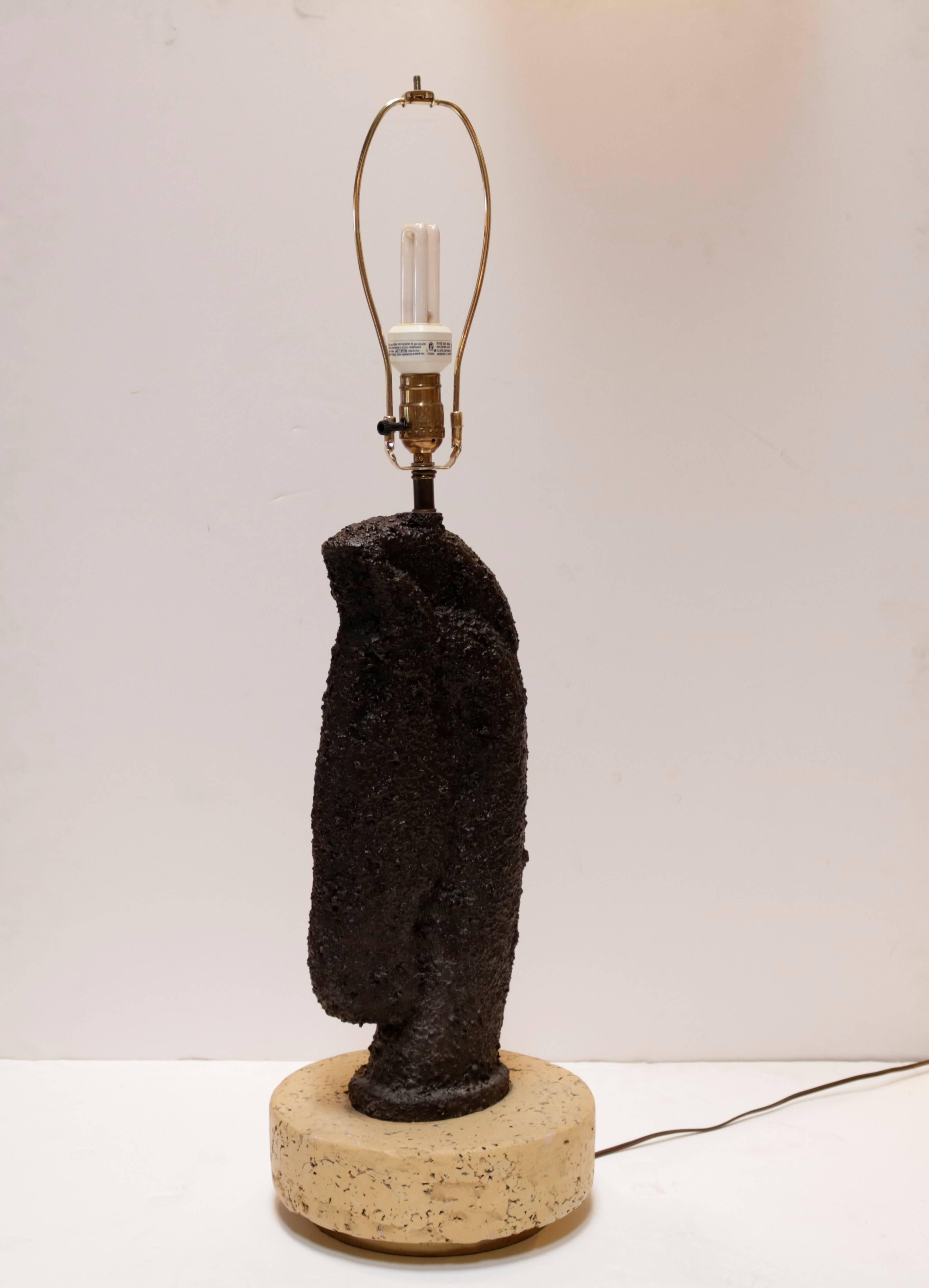 This unique pair of horse head lamps are rendered in bubbly black resin. They are mounted on thick cork platforms with inset brass bases. The new custom-made lampshades are a light beige linen matching the bases.