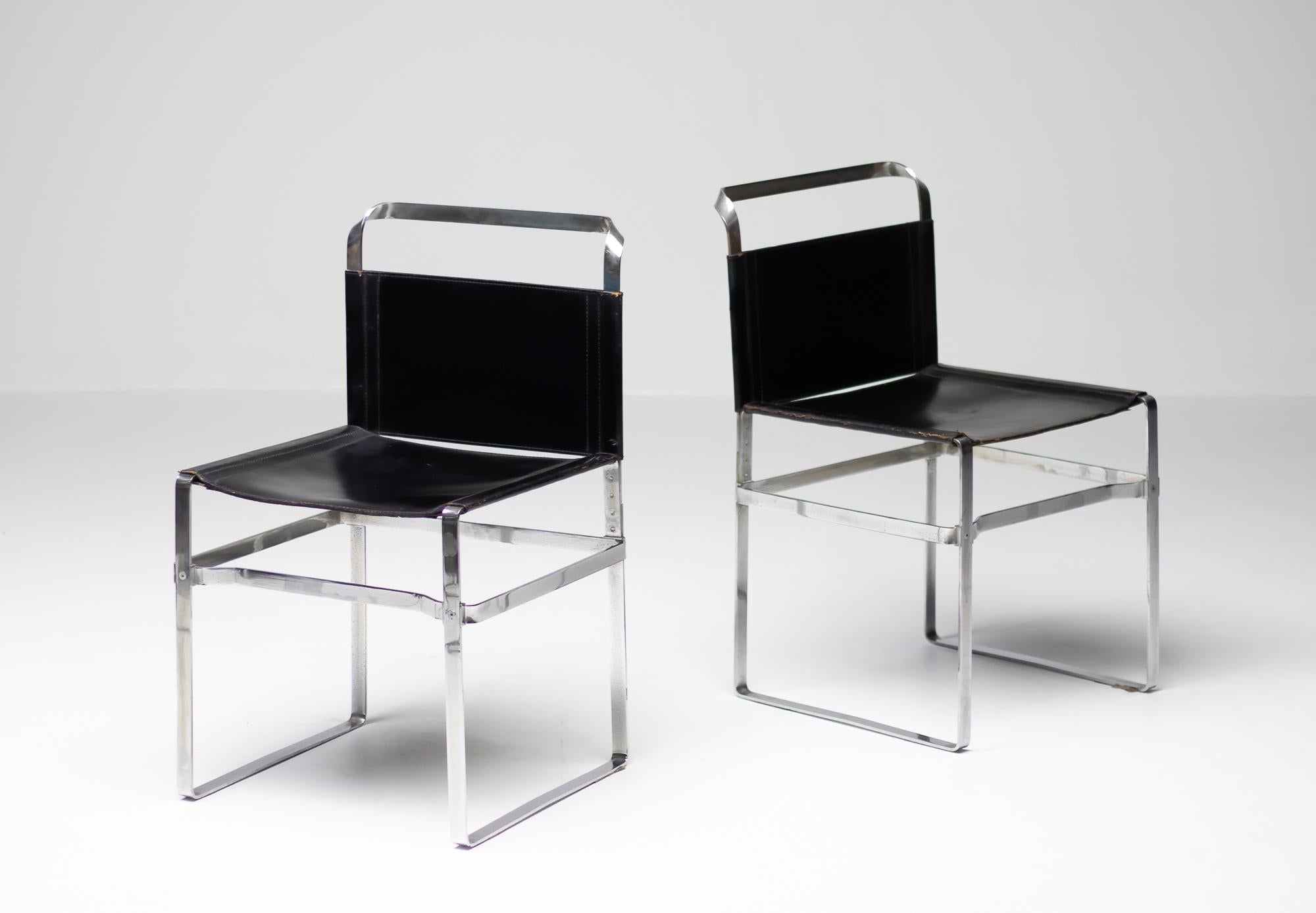 Elegant pair of side chairs made in chrome-plated steel strip and black leather.
Minimalist design with beautiful details.
Priced individually.