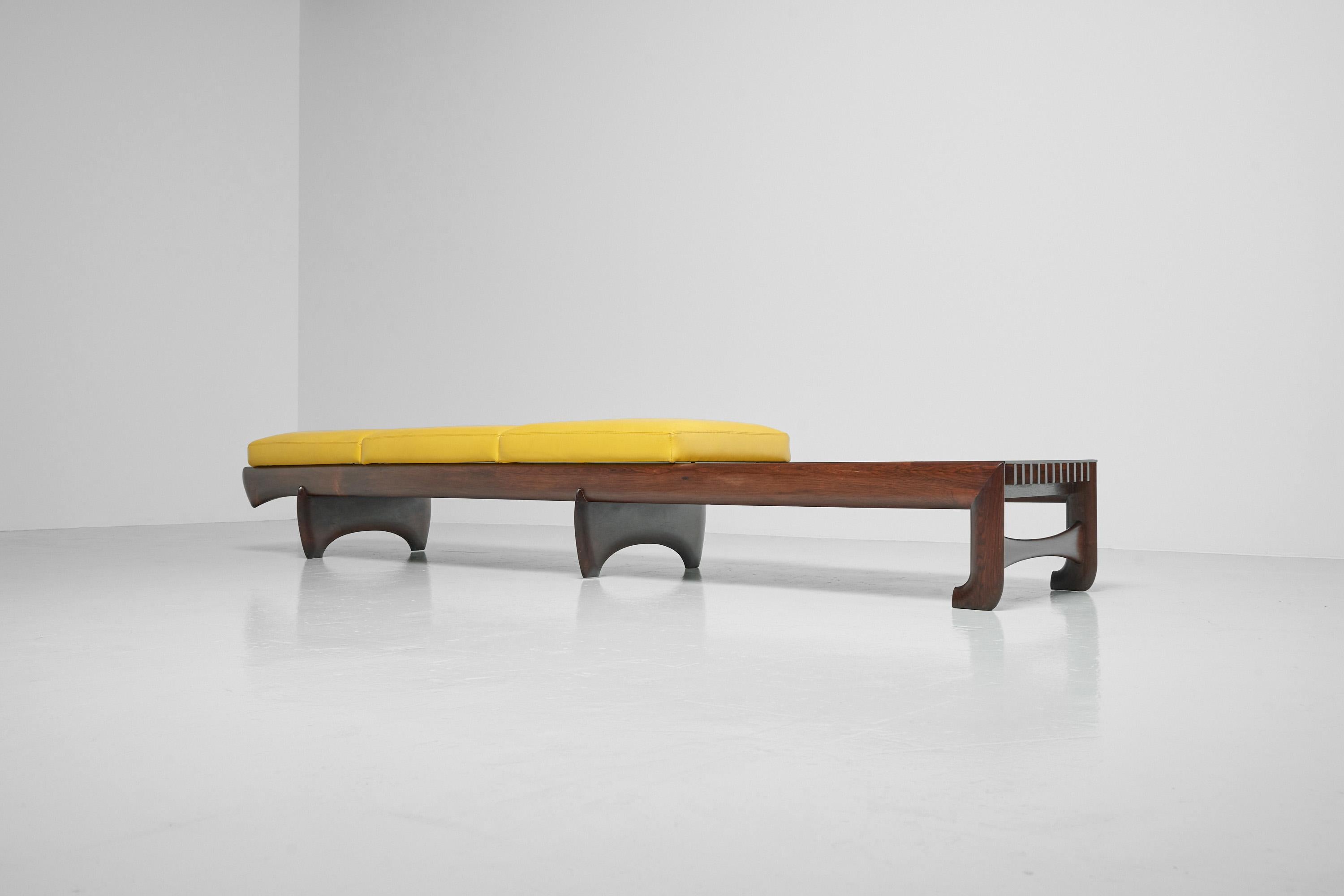 Eye catching unique long bench with integrated side table made by an unknown architect in Brazil in the 1960s. This solid rosewood bench has been surely inspired by Sergio Rodrigues and Carlo Hauner / Martin Eisler. It has features in the design