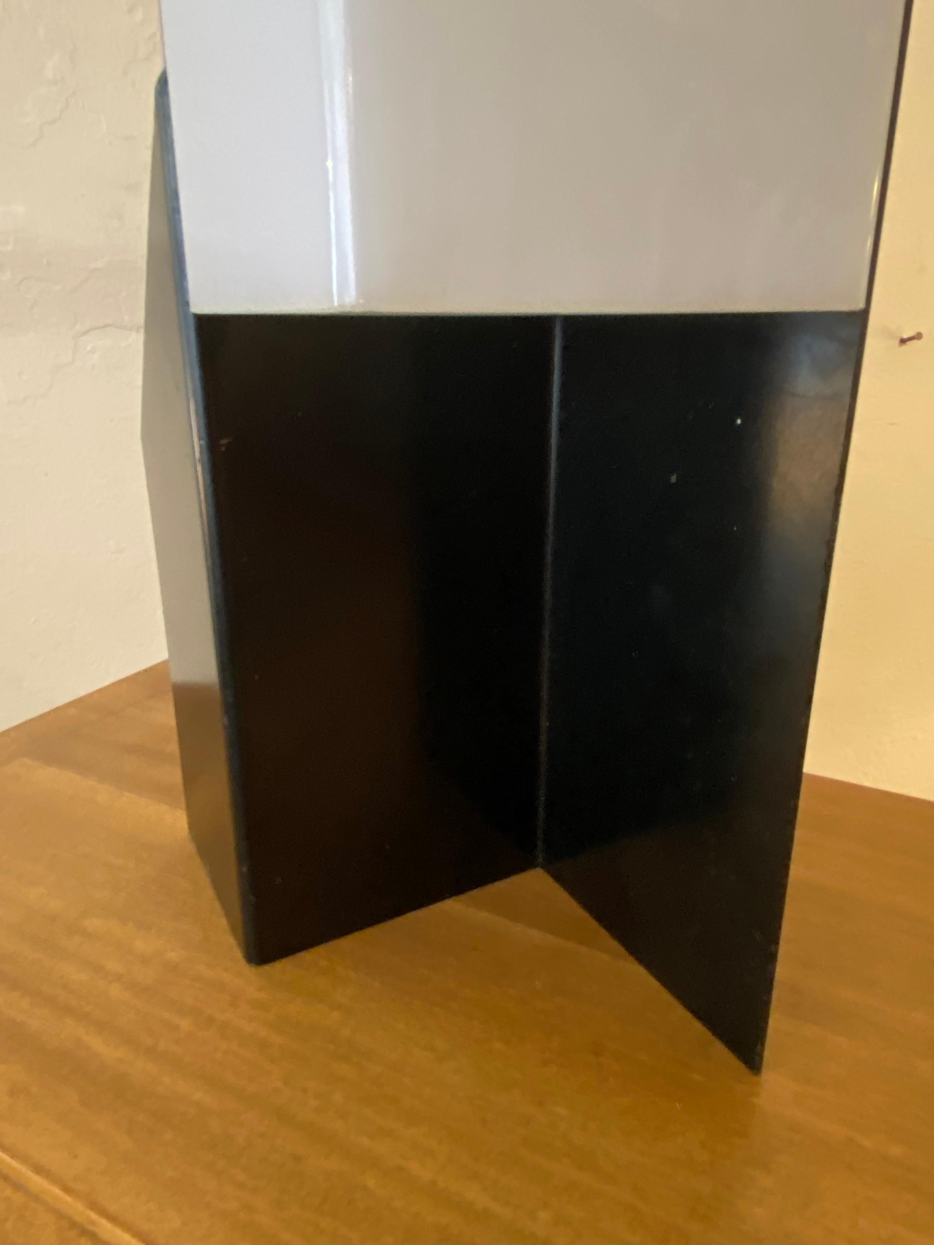 Architectural metal table lamp with plastic shade. Nice simple look and design, probably dates to the late 1970's or early 80's. Body is painted black with a white shade, two sockets give light up and down.