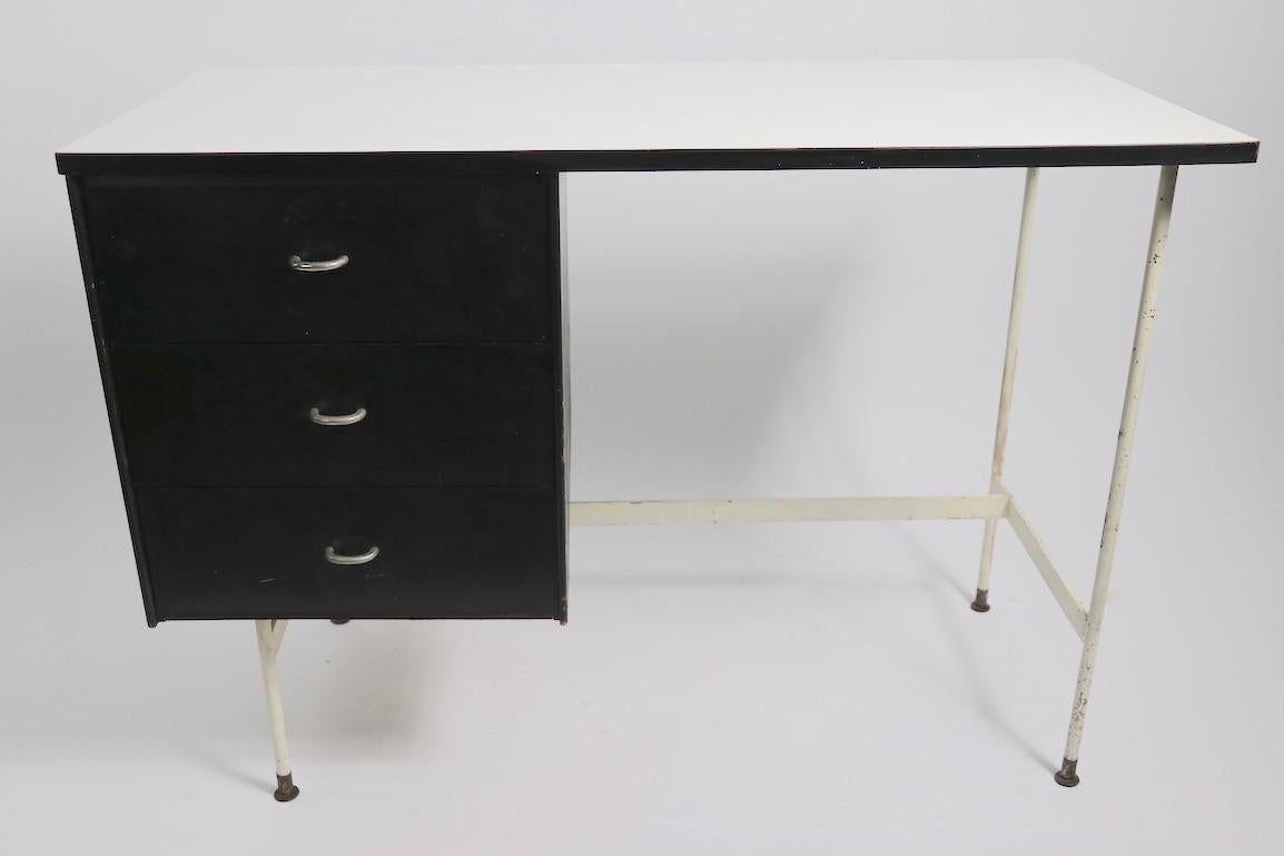 Chic architectural desk by Thonet in the style of Paulin. This desk features a bank of three black drawers, each having a semicircular aluminum handle, a white formic top, white metal frame and legs The desk was manufactured by Thonet in the style