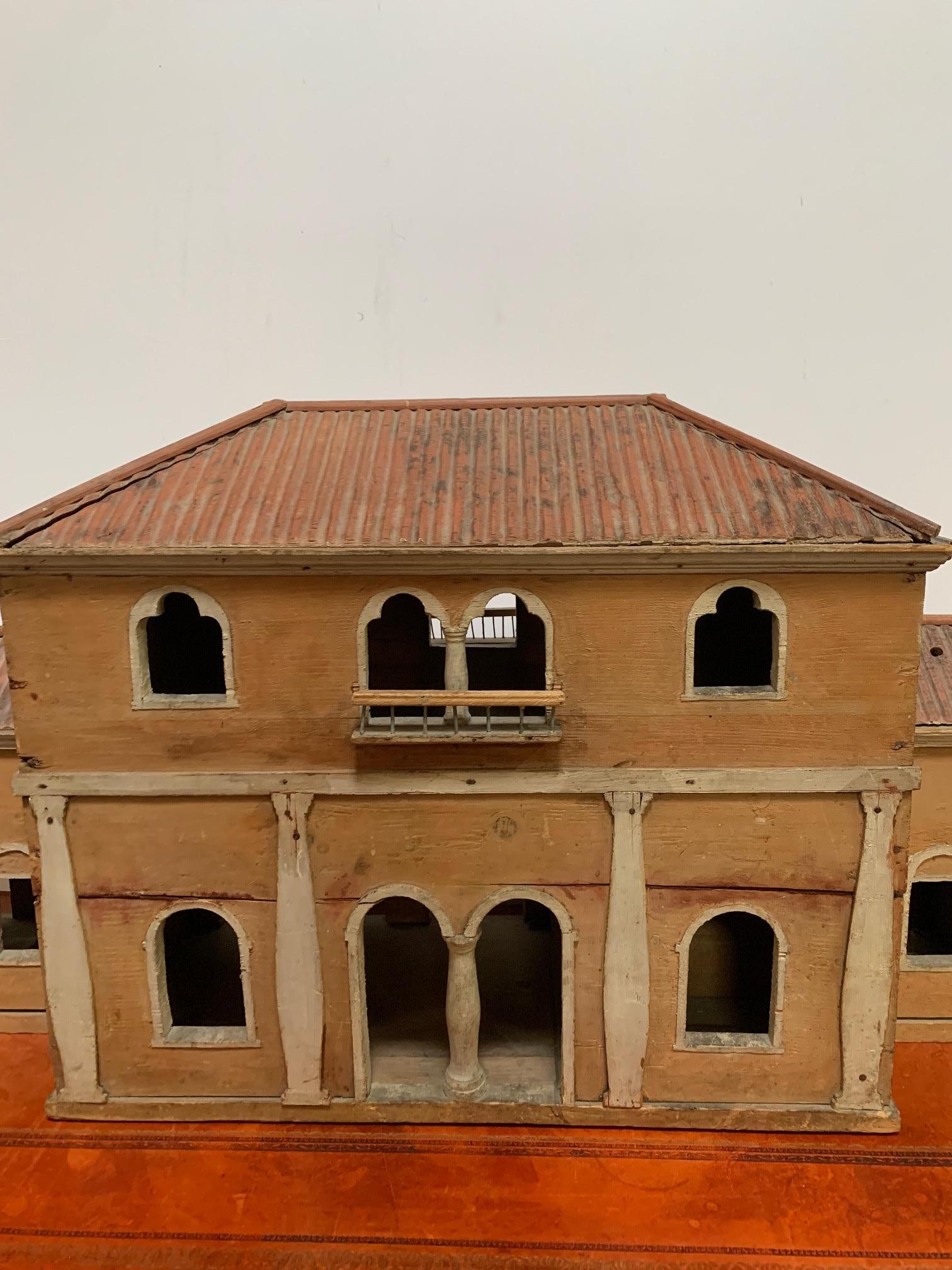 Model of architecture, in wood, based on an Italian Villa.
The piece has sinuous curves and arches and an exceptional , realistic looking roof all beautifully painted in Tuscan colors. 