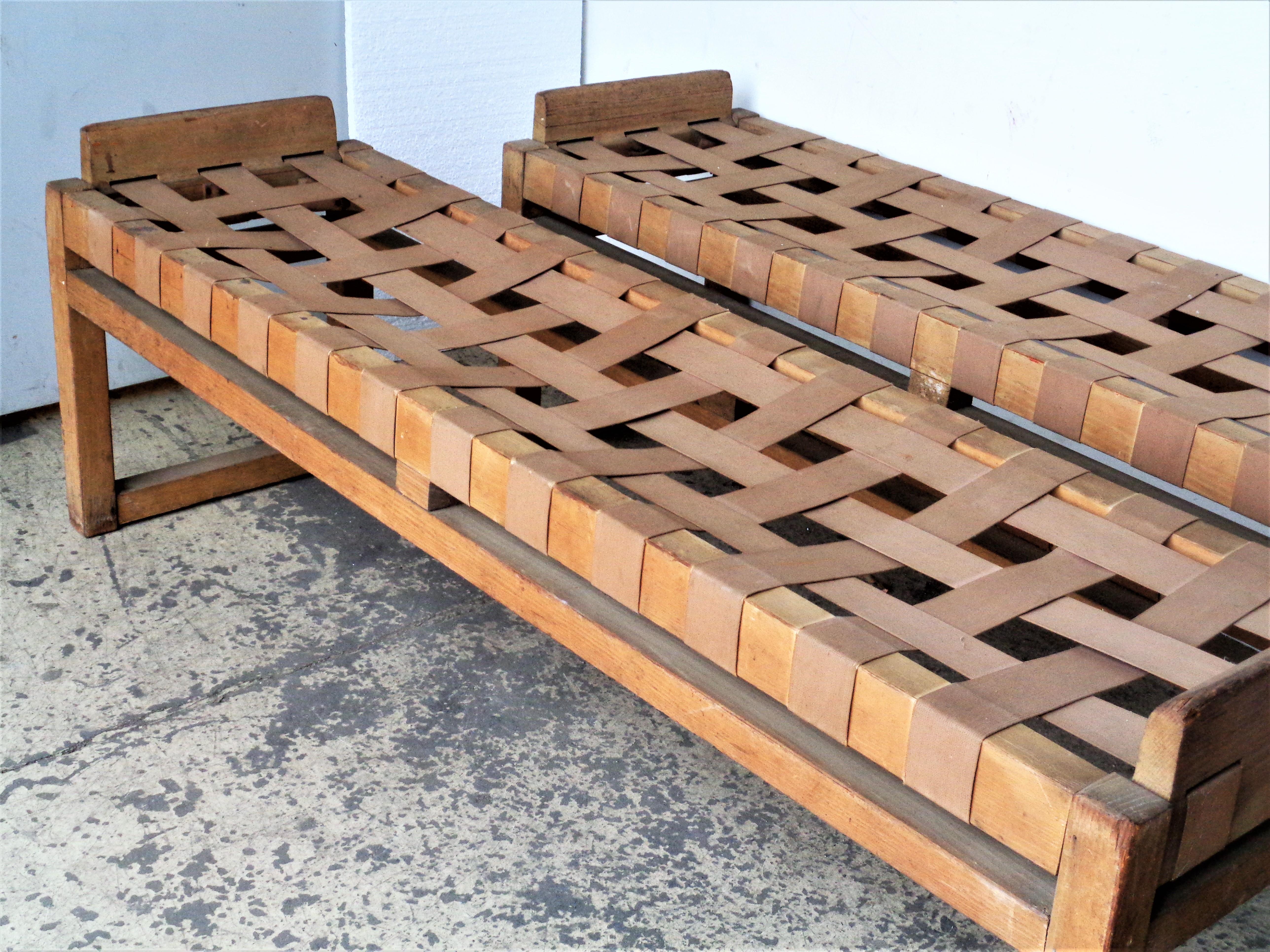 Pair of long wood benches with canvas straps in all original vintage condition with no restorations. The wood framework in old surface. The canvas webbing fully intact w/ no broken straps. Unusually great looking with a beautiful architectonic