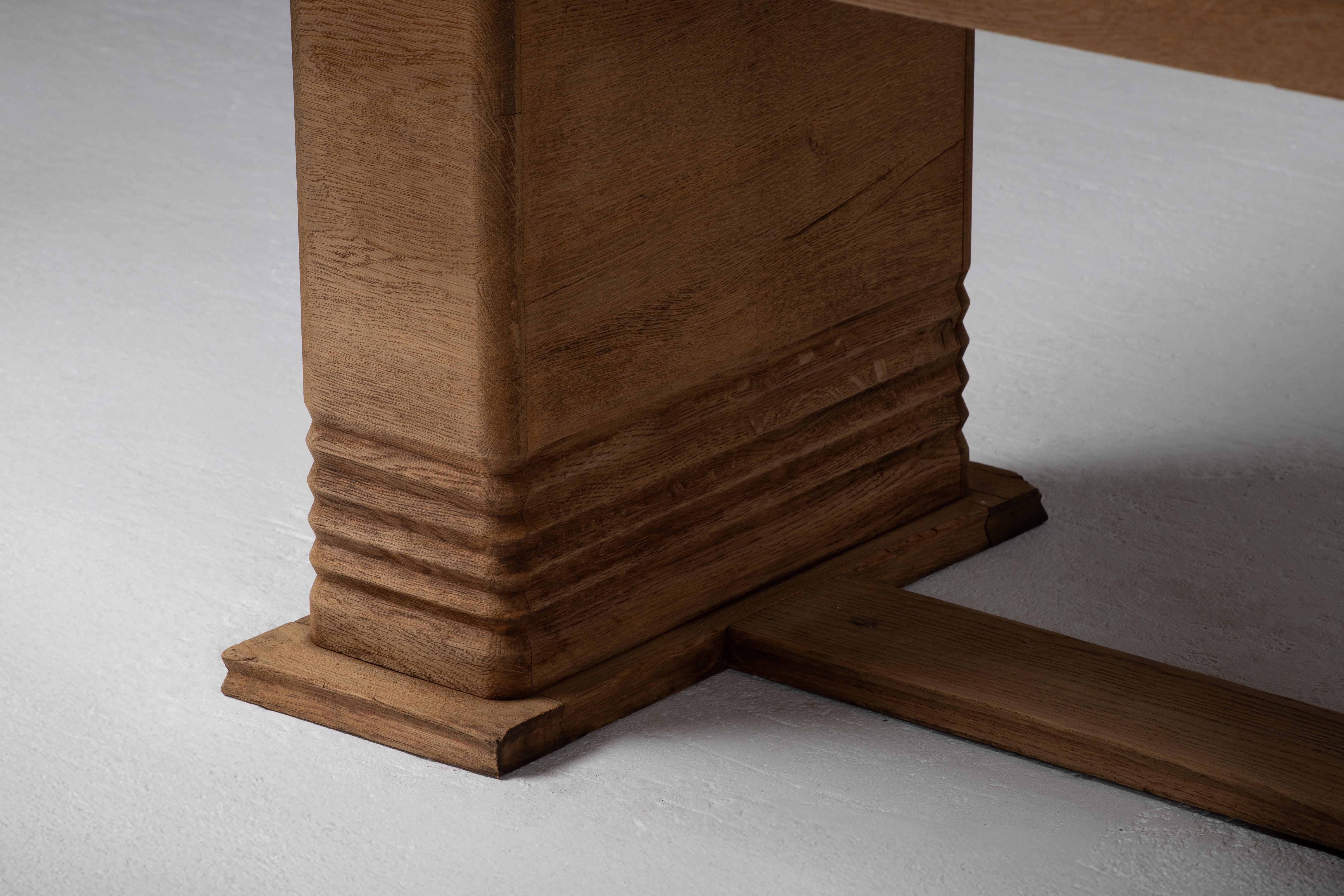 Architectural Oak Dining Table with Parquet Top, France, 1950s
Form distilled to mass and rhythm — a collector’s piece of sculptural restraint.

This commanding French oak dining table, crafted in the 1950s, distills post-war design to its