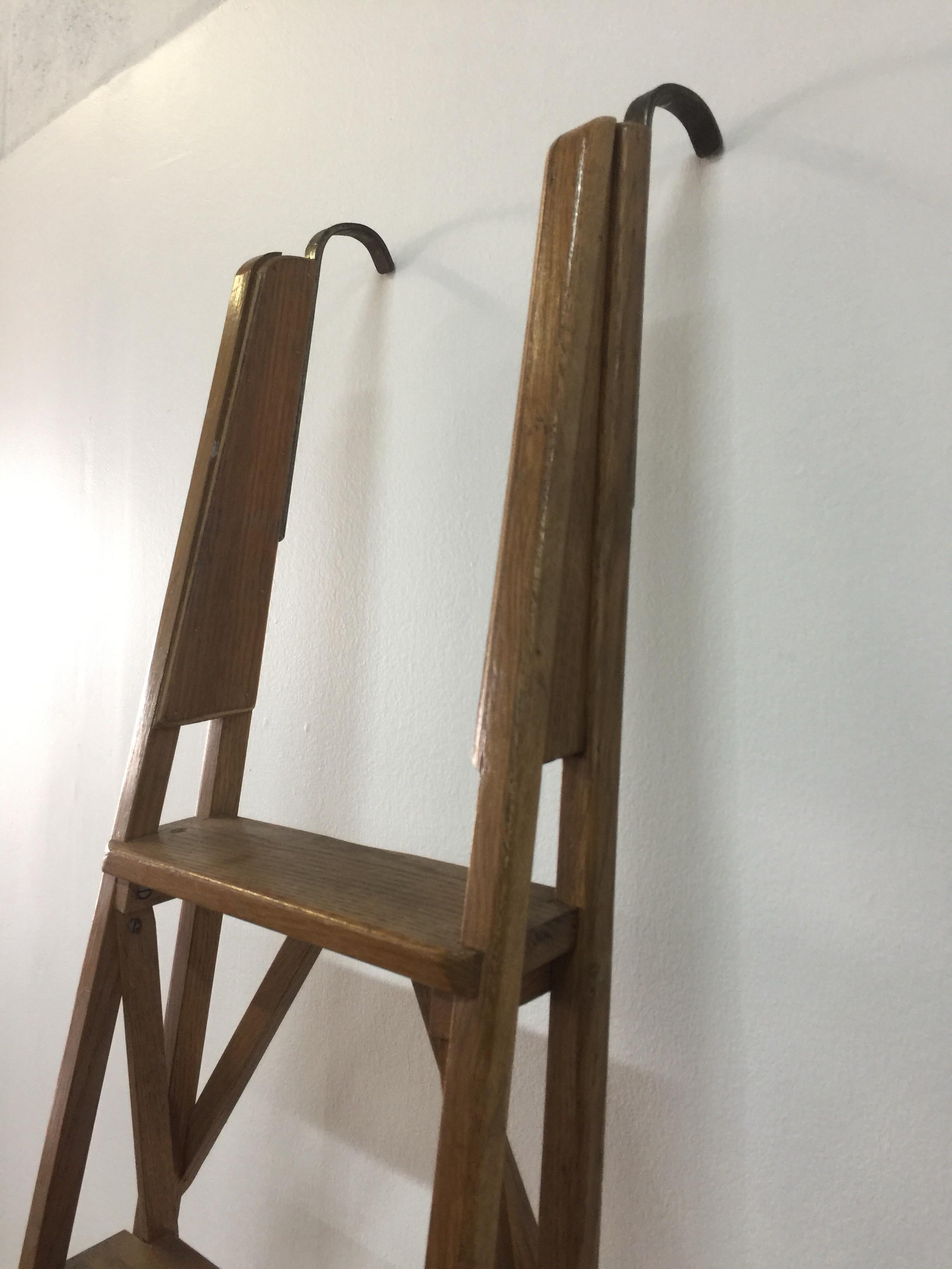 In the manner of Franco Albini, this intricately designed, early made library wall ladder with all original pieces. It originally was held by bar (bar height would be at 78 inches when ladder is leaned at the correct angle against the wall).  The