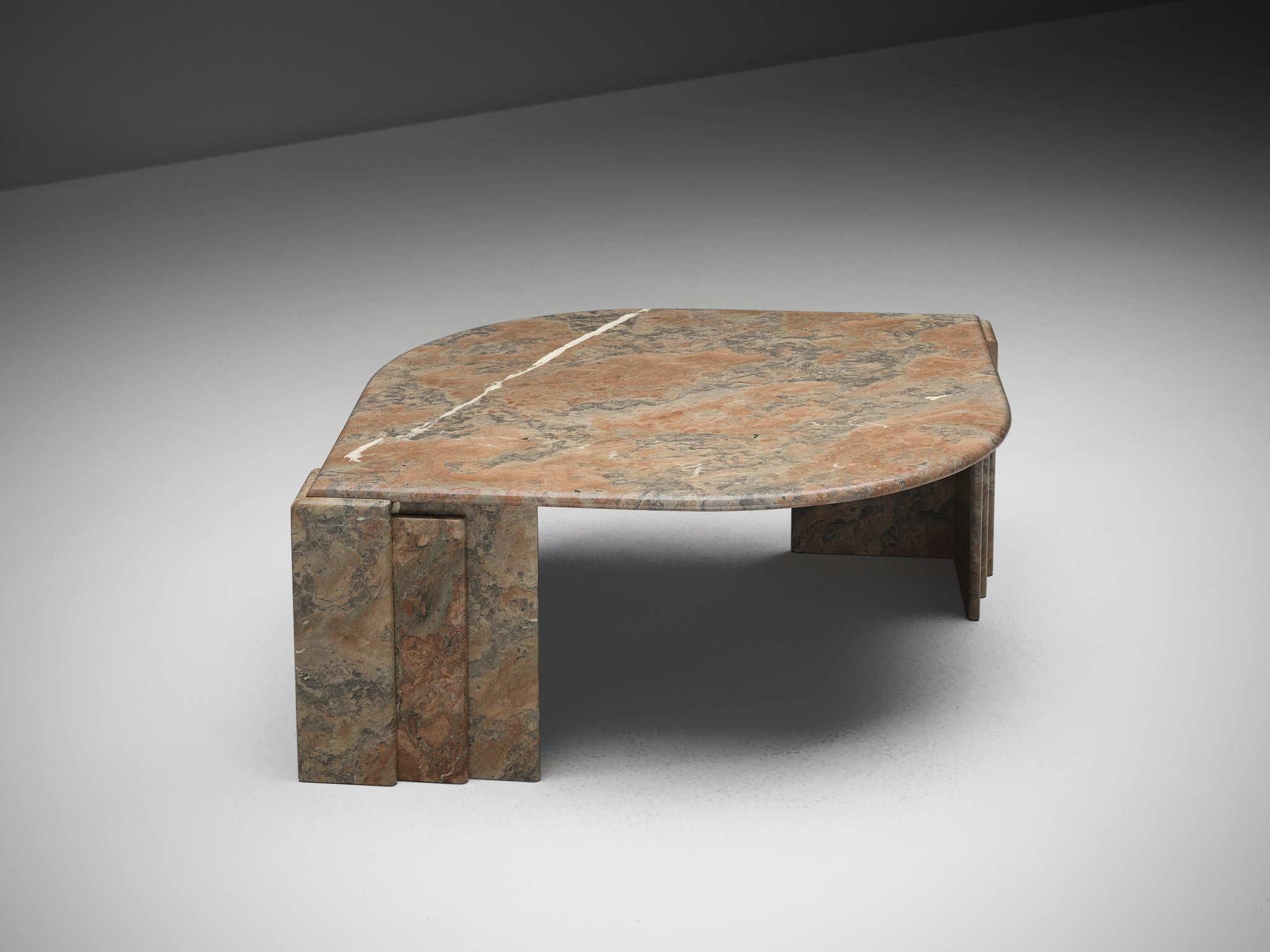 Oval coffee table, marble, Italy, 1970s

This sculptural coffee table has an eye-shaped top that rests on two triangle shaped legs. These consist of three triangles arranged together and have a graphical appearance. The dynamic, vivid vein of the