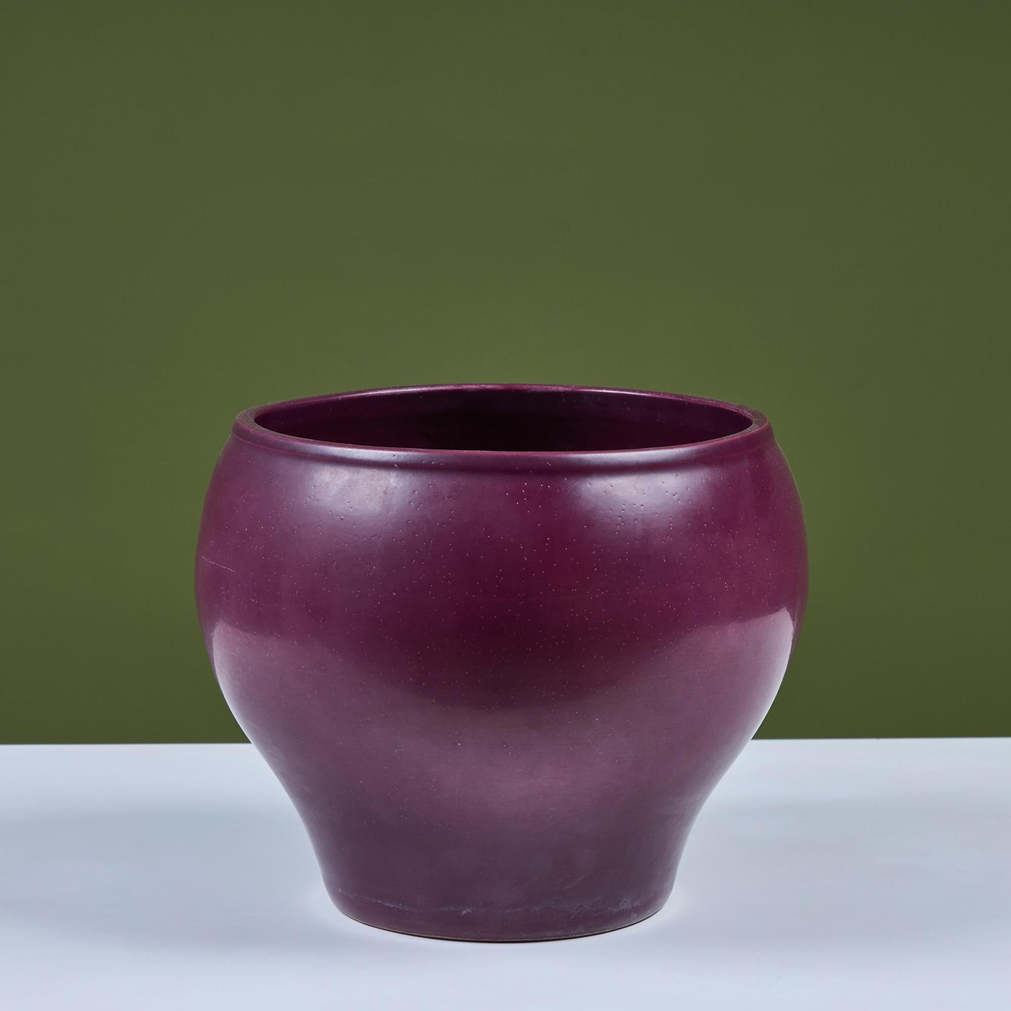 Medium sized planter by Architectural Pottery with a pop of color in a purple glaze. This planter has a bell-shaped body with its widest section through its middle region.

Dimensions
11.5