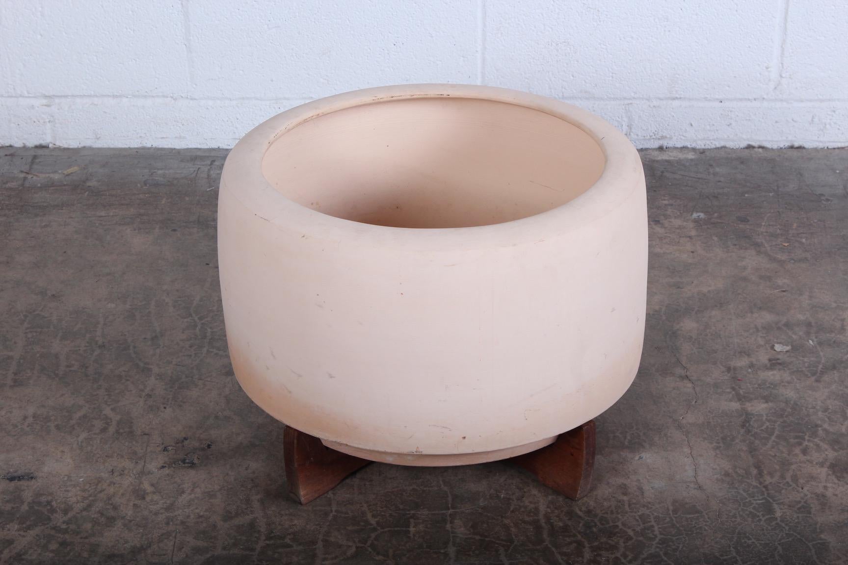 An early bisque tire planter with original redwood base by Rex Goode and John Follis for Architectural Pottery. Unsigned.