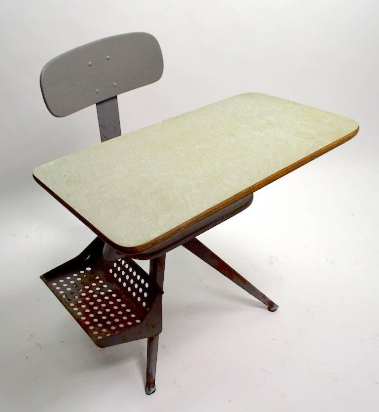 Great architectural design school desk, with obvious Jean Prouve influence. The desk is painted grey metal, with a green tint formica writing surface. Sophisticated style, sculptural form, and high quality commercial construction, will withstand