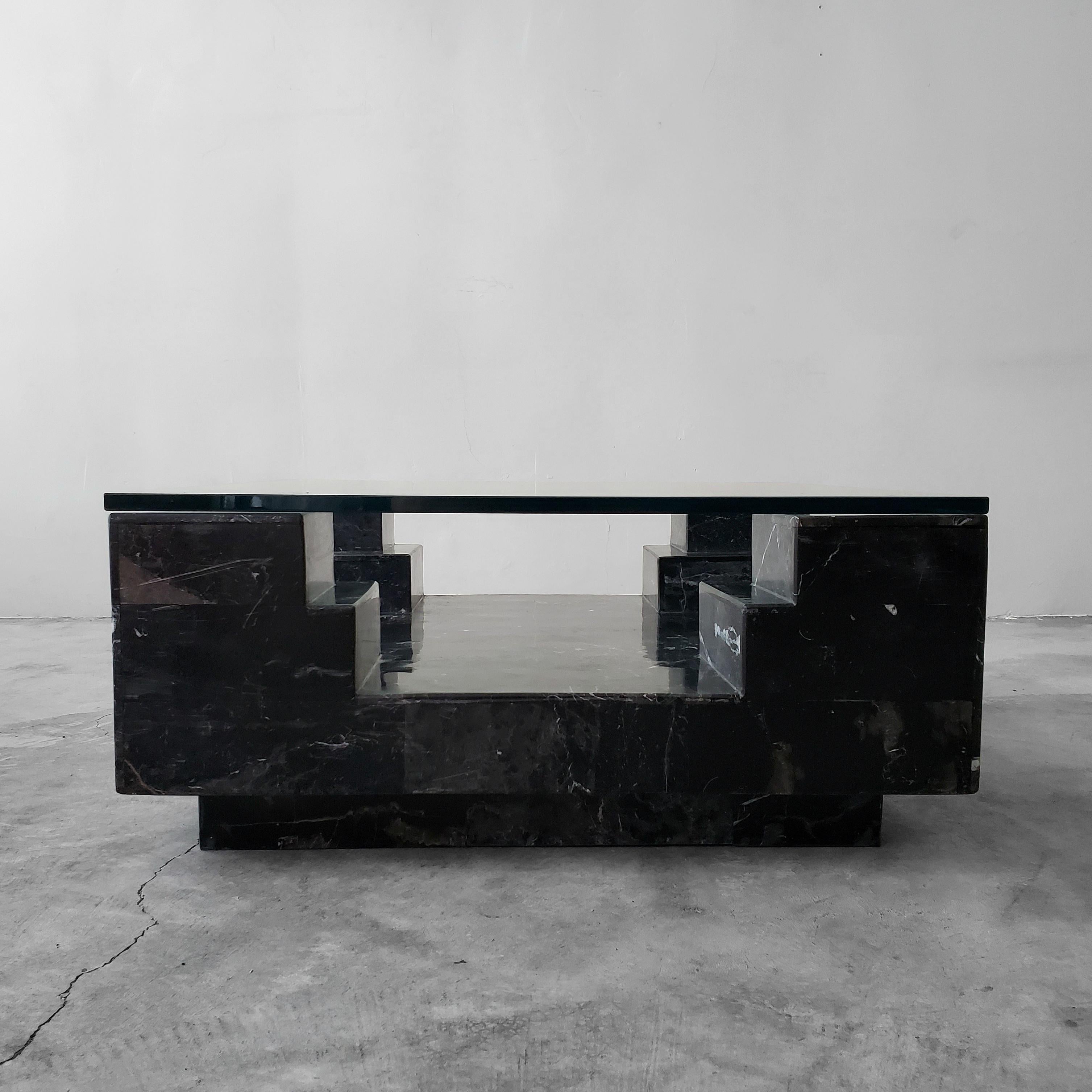 Super unique, architectural, square Italian nero marquina marble and glass coffee table. Beautiful black and white marbling and the unusual shape make this a real centerpiece. A true designer piece.

Table is in great condition overall.

 
