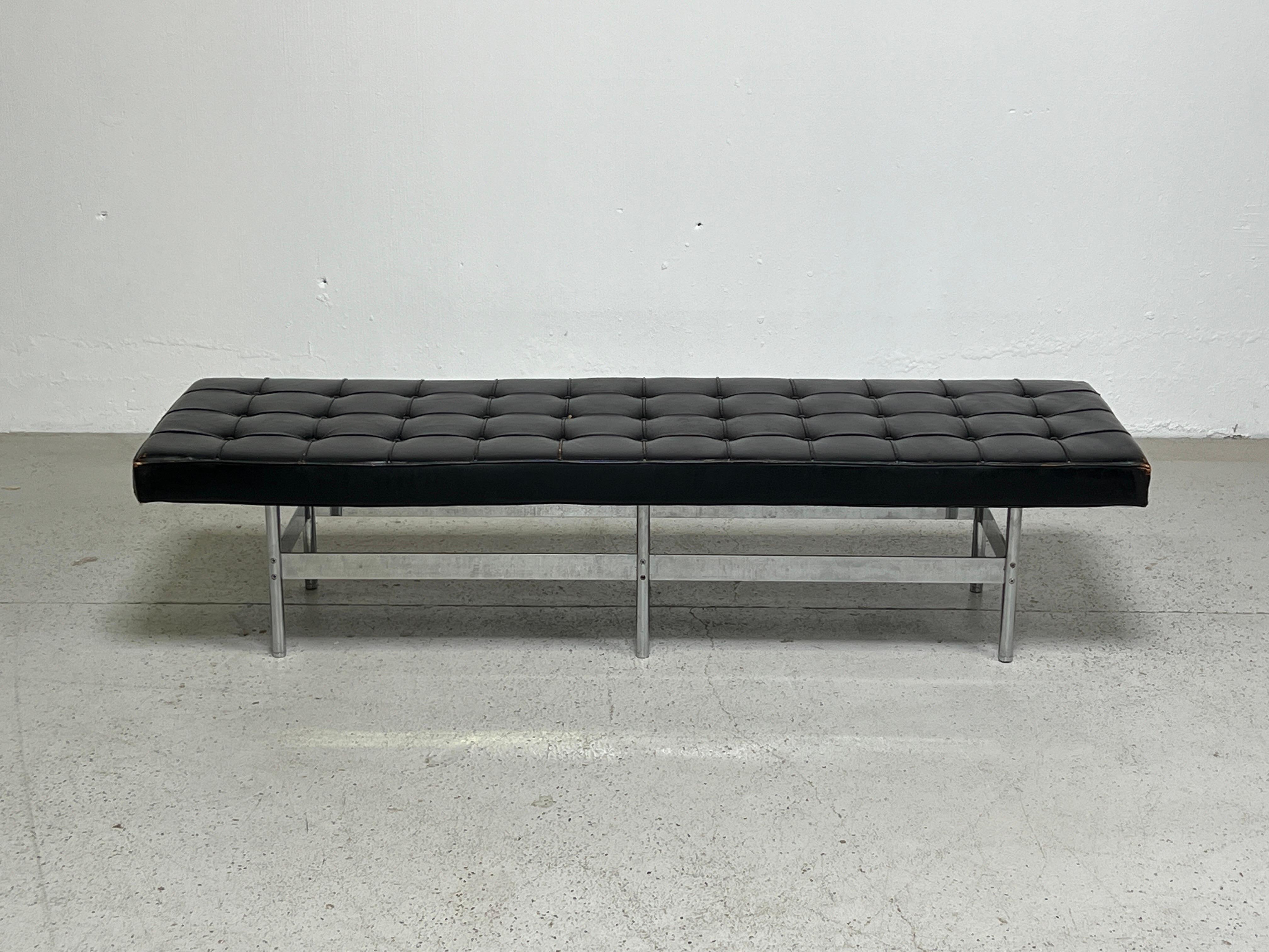An extremely well made bench with polished stainless steel base and patinated leather top.