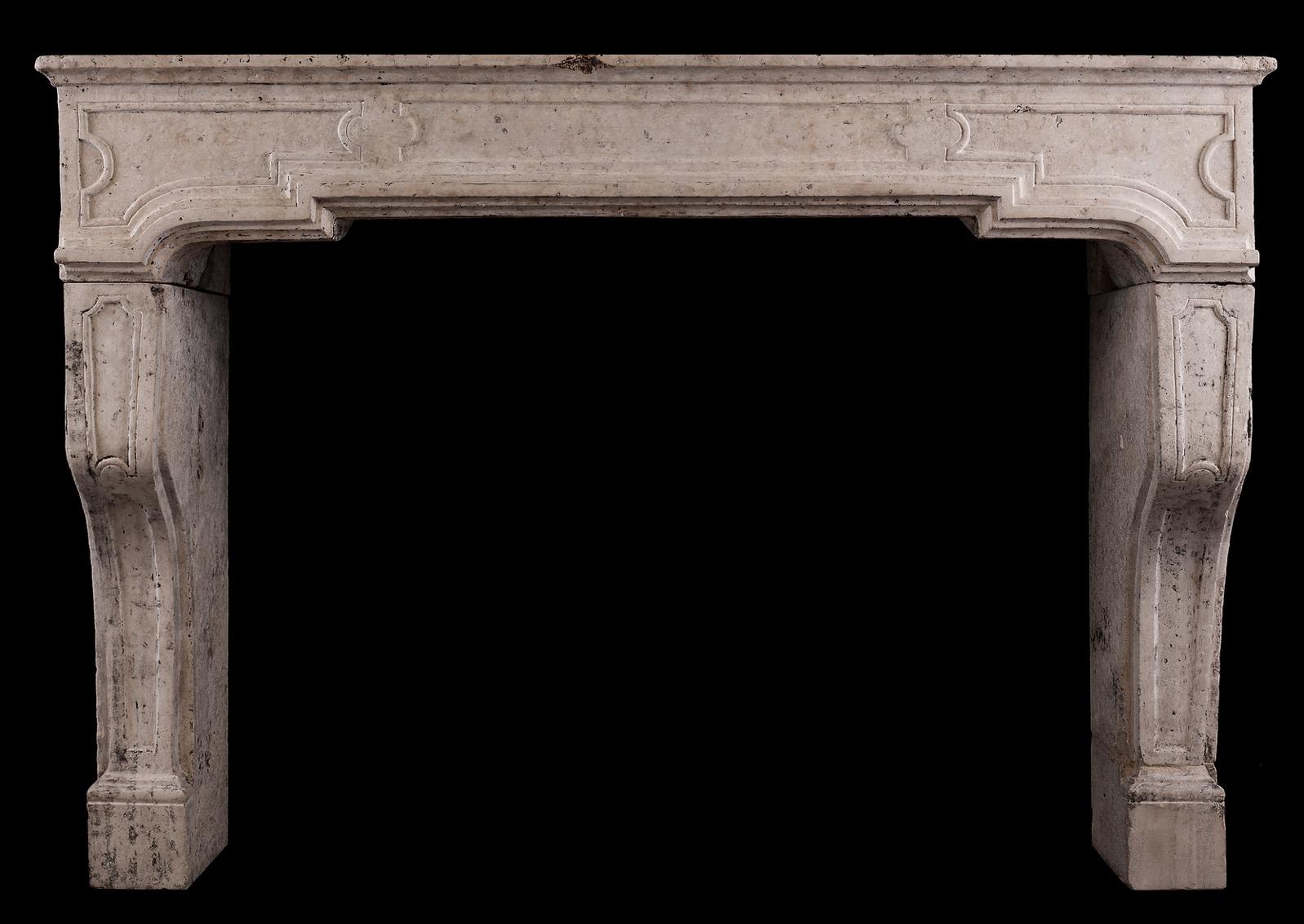 An architectural French stone fireplace. The panelled frieze with shaped, panelled jambs below. A rustic stone with nice, aged patina. French, late 18th-early 19th century.


Shelf Width:	1555 mm      	61 1/4 in
Overall Height:	1090 mm      	42 7/8