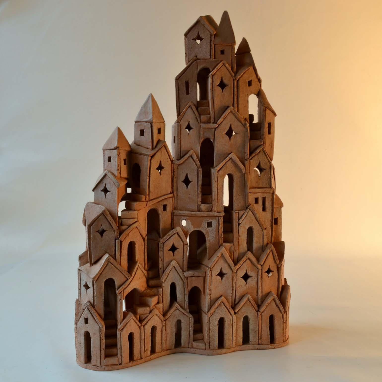 Tower build in red baking clay by Dutch artist Arie Bouter, Gouda 1995 (B. 1942) is based on medieval European architecture and has a strong resemblance with Mont St. Michel in France, the Tower of Babel but also refer to M. C. Escher's drawing