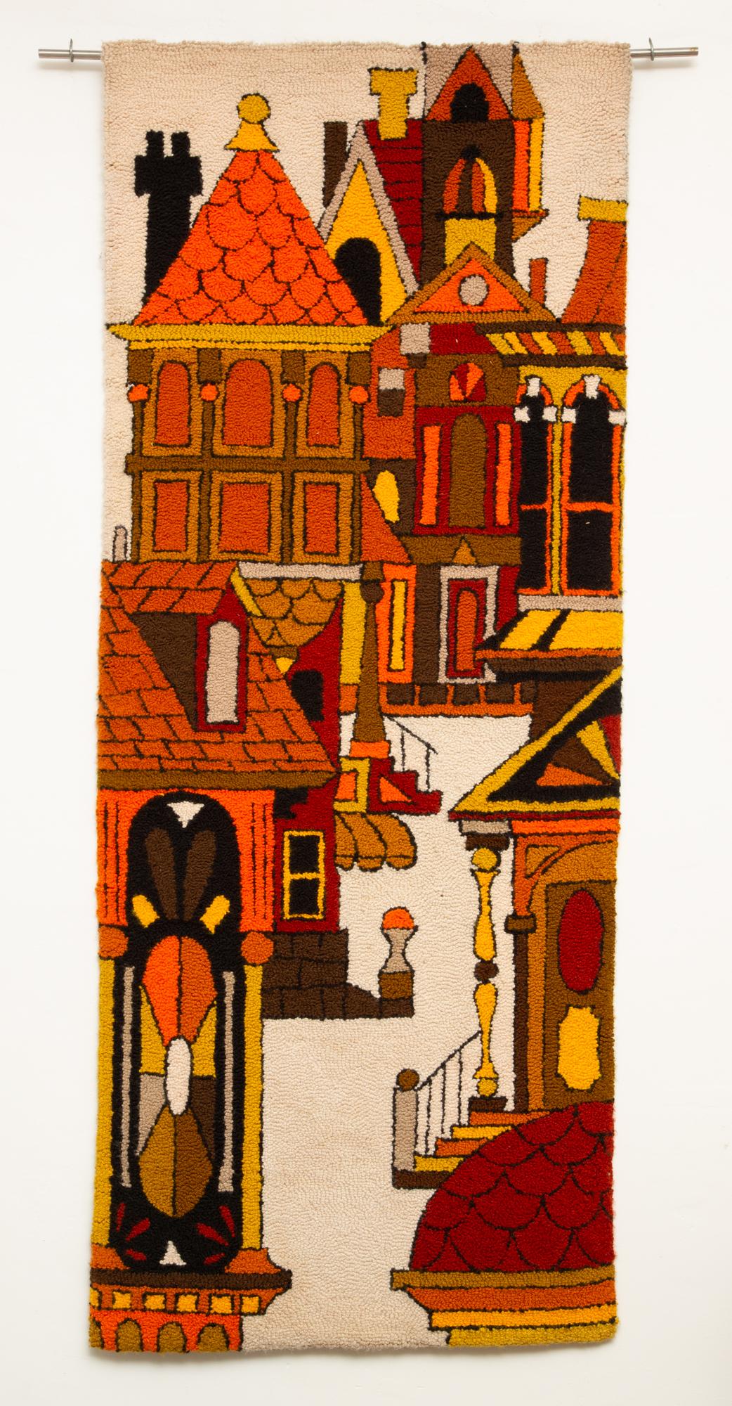Large-scale architectural carpet weave tapestry, circa 1970s. A vivid and lively warm-toned wall hanging with cityscape and Victorian architecture imagery featuring forms and perspectives that are reminiscent of a more simplistic take on cubism. The