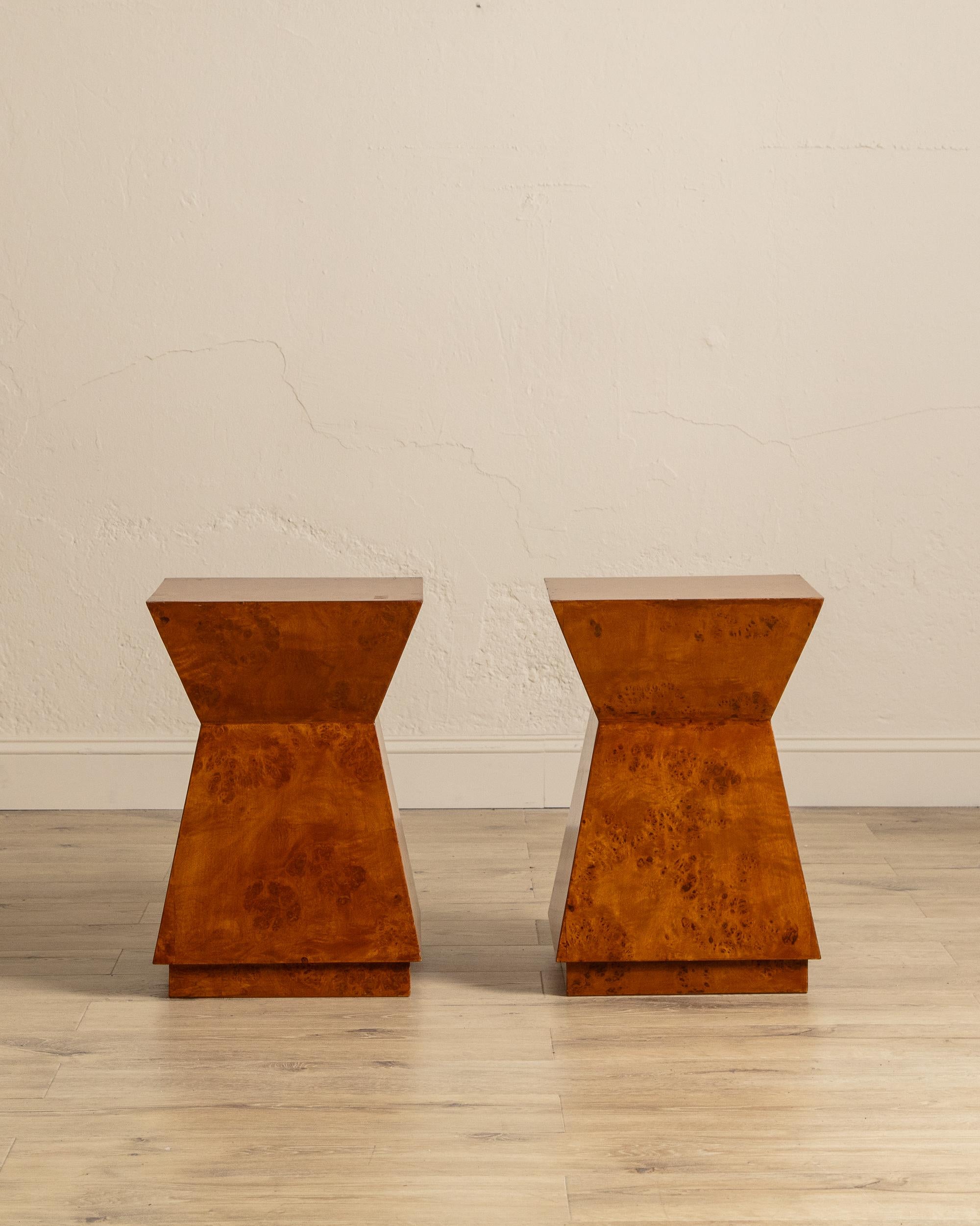 Offered individually, these modernist burl wood side tables showcase a bold geometric silhouette and richly figured veneer that makes each one a statement of its own. The inverted trapezoid form creates a striking sculptural profile, with sharp