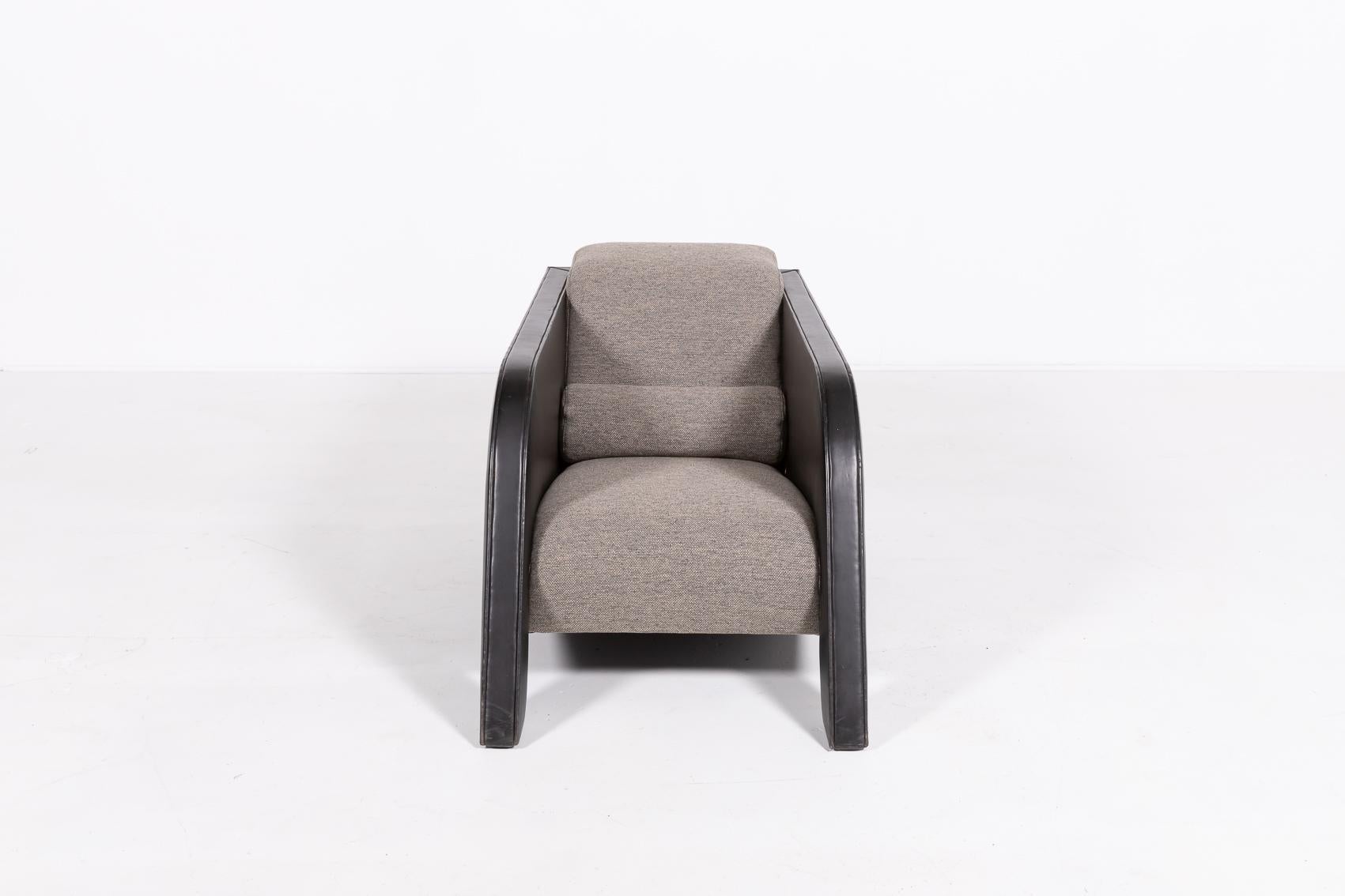 Spectacular design lounge chair from 1980’s by Ulf Moritz., Netherlands. The armchair has unique shape which makes it a direct eye catcher, limited production. The frame is upholstered in black leather, woolen fabric seat