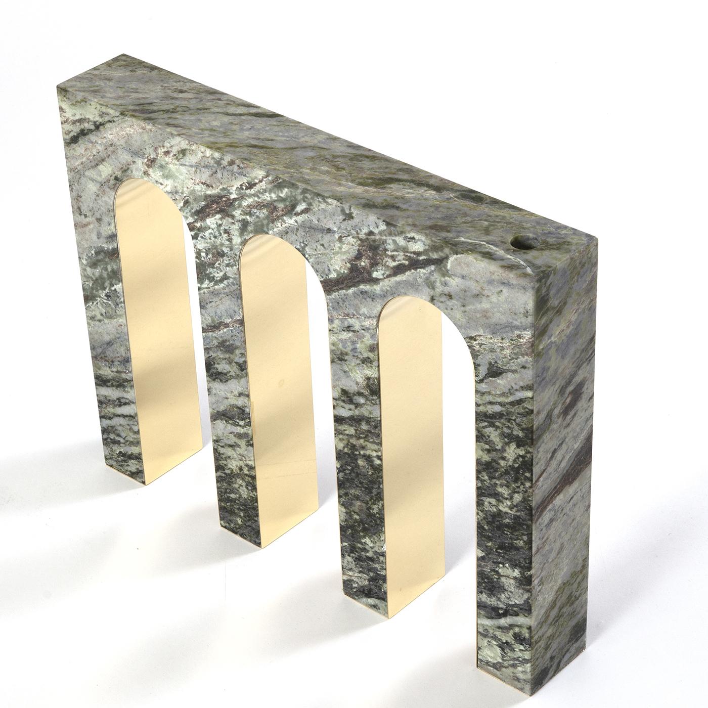 Merging classical inspiration and metaphysical art, inspired by the dream-like piazzas of De Chirico's paintings, this splendid vase is a sculptural masterpiece crafted of polished Irish Green marble. The top features a hole to insert floral