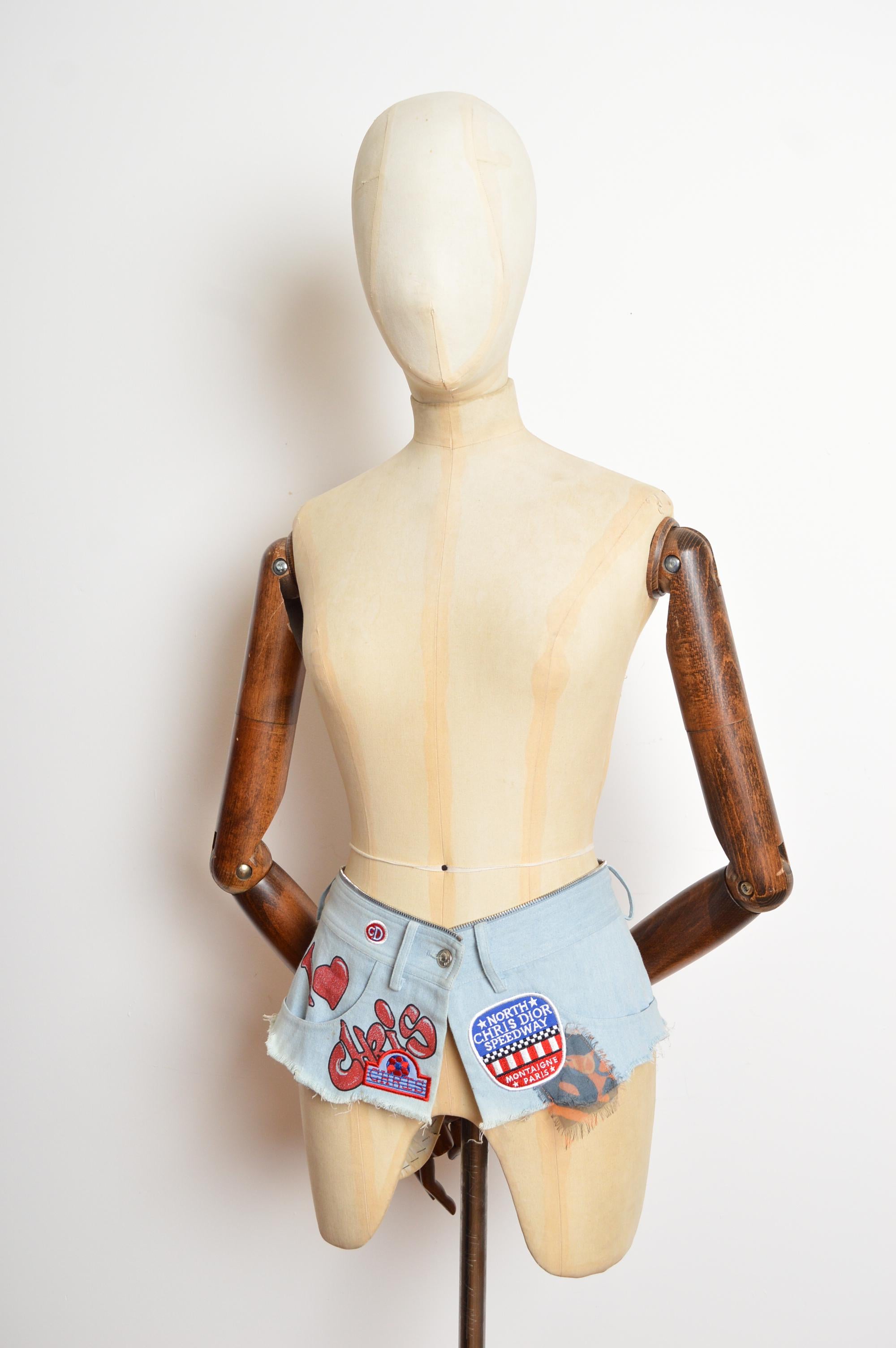 S/S 2001 Christian Dior by John Galliano Micro Denim Skirt Belt with patches
Size; 26-27” waist 
Measurements are provided in inches (‘’)
Waist; 26-27” waist 
Length; approx 6”
Condition; Fantastic Condition with no major notable flaws. 
Material;