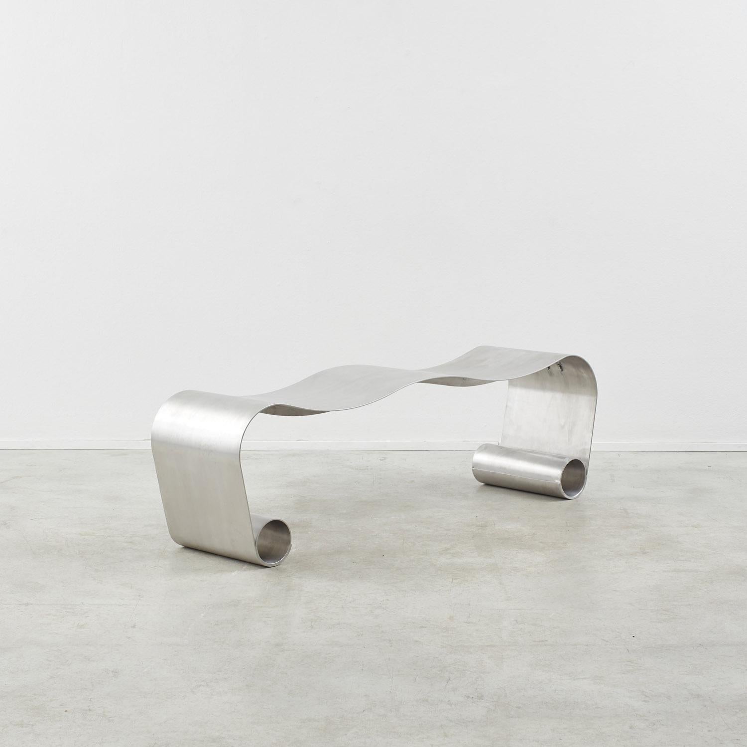 This distinctive bench in aluminium was designed exclusively for Béton Brut by Archive for Space. An exercise in imaginative modern metalwork, it is made from a single sheet of unsealed aluminium, which is gently folded and welded into two tubes to