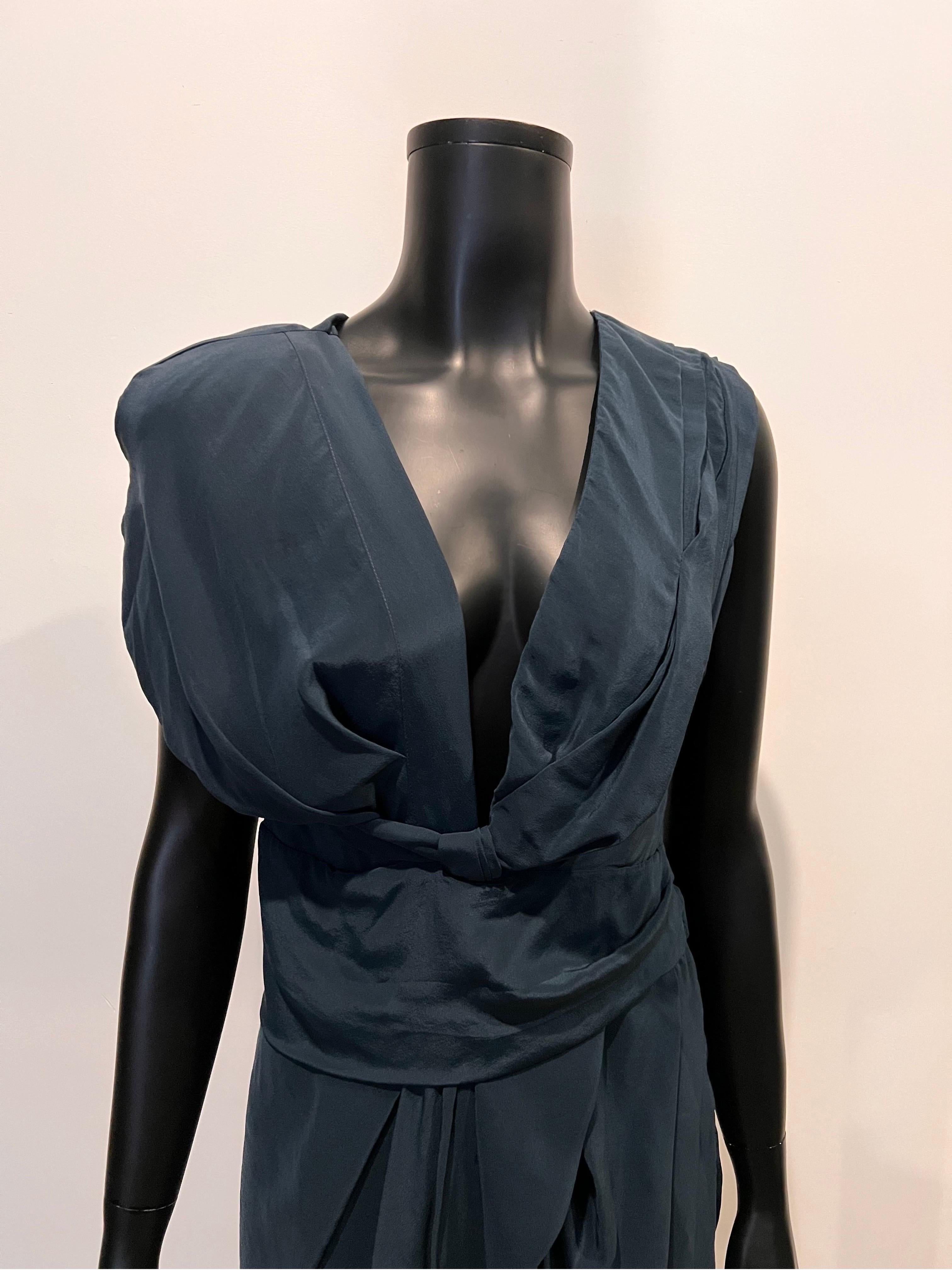 An early 2000's archive Isabel Morant wool and silk cocktail dress with unique asymmetrical cut in a beautiful navy colour. 
Irregular pleated design through centre front creates this unusual shape, low cut deep V to the waist gives this dress a