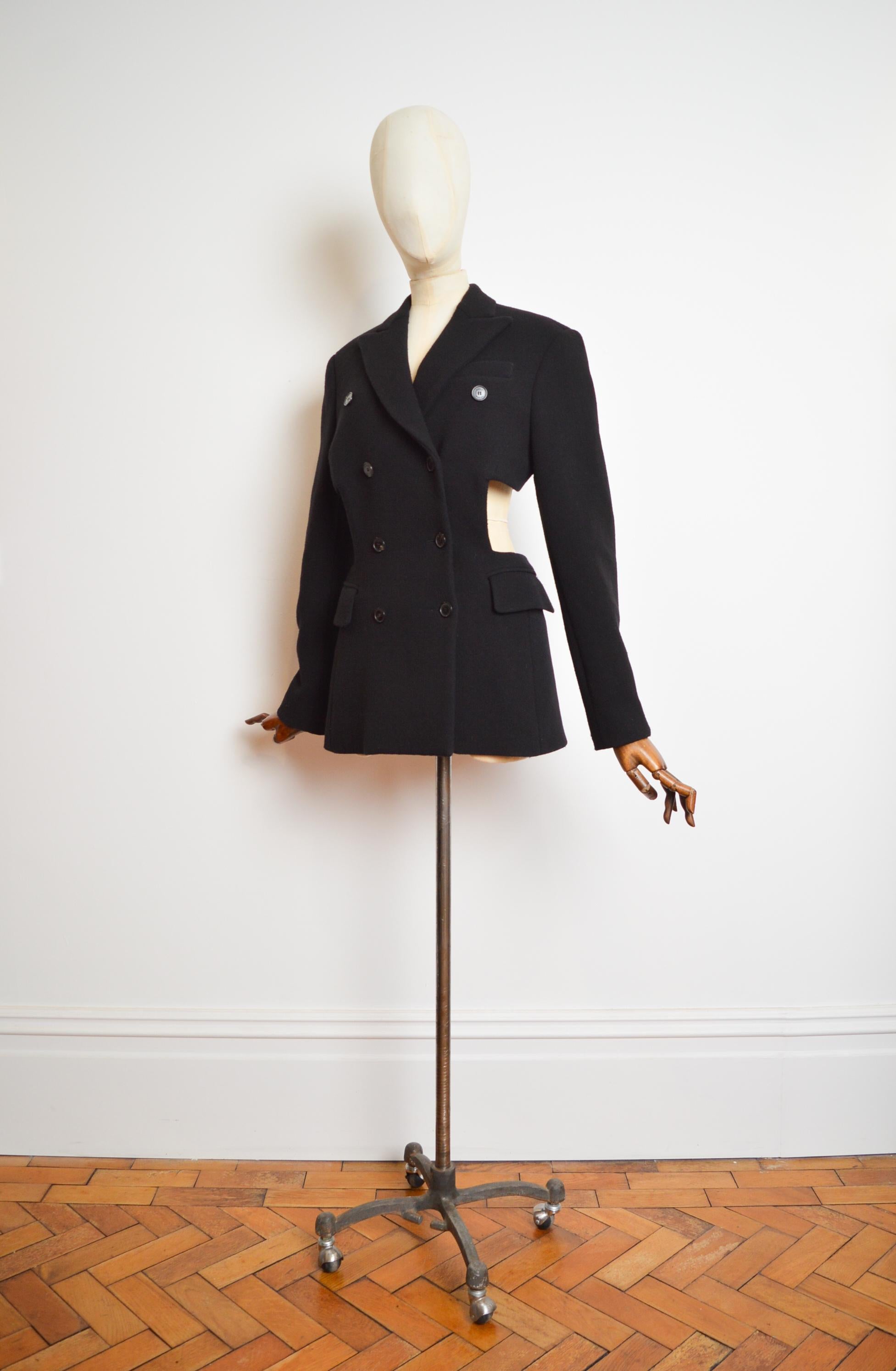 A Unique, demure black wool cut out blazer by SONIA RYKIEL.

Runway Sample, Hand made in the Ateliers in Paris, France.

This Garment is superb both styled as a Mini Dress or as a suit Jacket.

Measurements are provided in inches;
Pit to Pit;