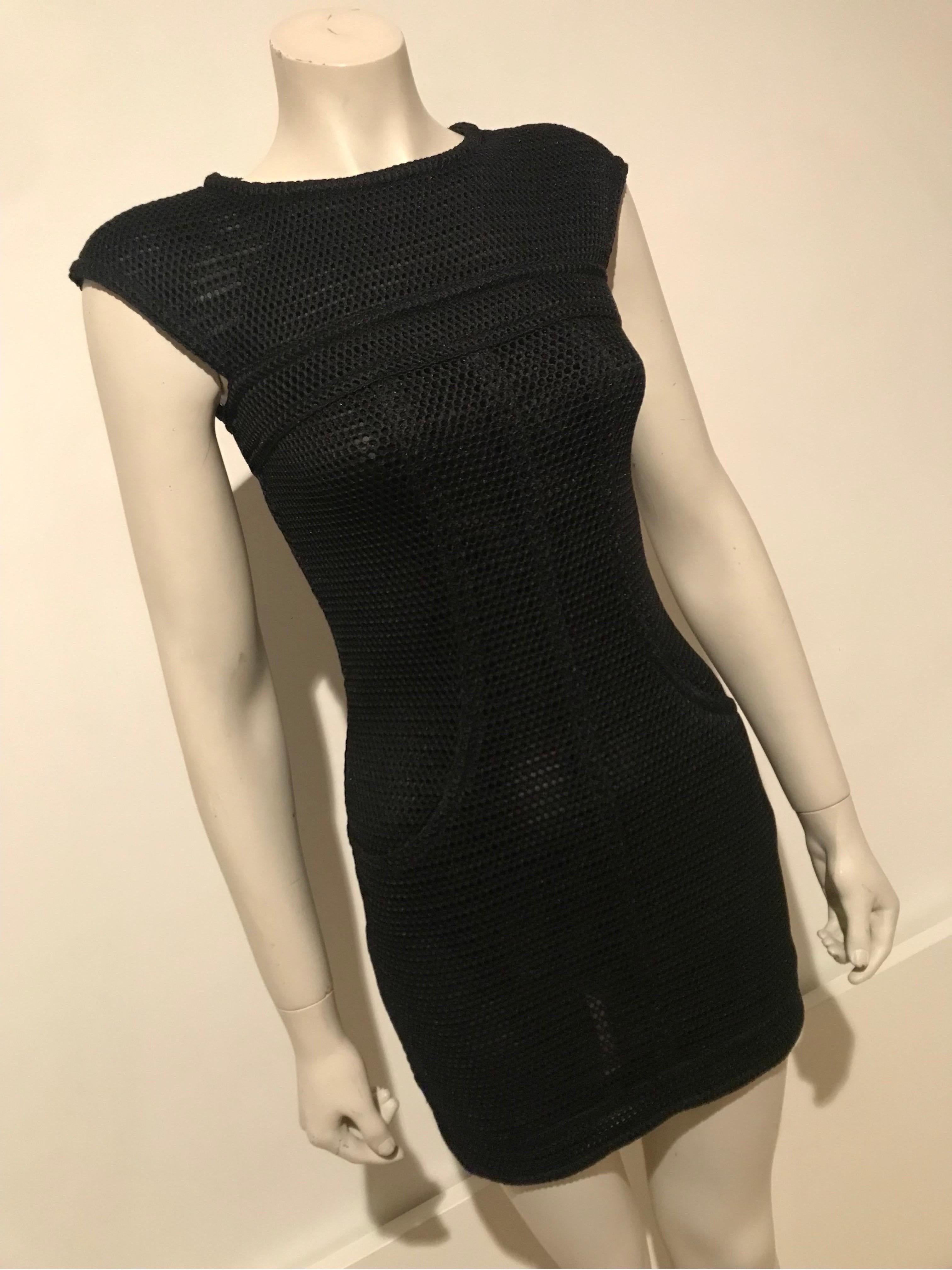 This 2000's Chanel mesh mini dress is from the Karl Lagerfeld era and symbolises this exciting era of the famous French house.

The dress is well fitted but the mesh fabric has quite a bit of stretch, the silk lining also has stretch being a knit