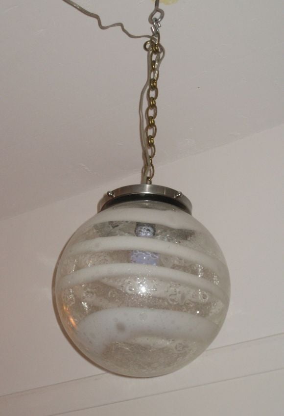 Distinctive Thick Mottled Glass Globe hanging fixture (converted from a table lamp). The Globe has a Decorative Spiraling Pattern of Clear and Opaque Glass and is attached to a Chrome fixture by three pins. A Single Edison Socket Holds up to a 60