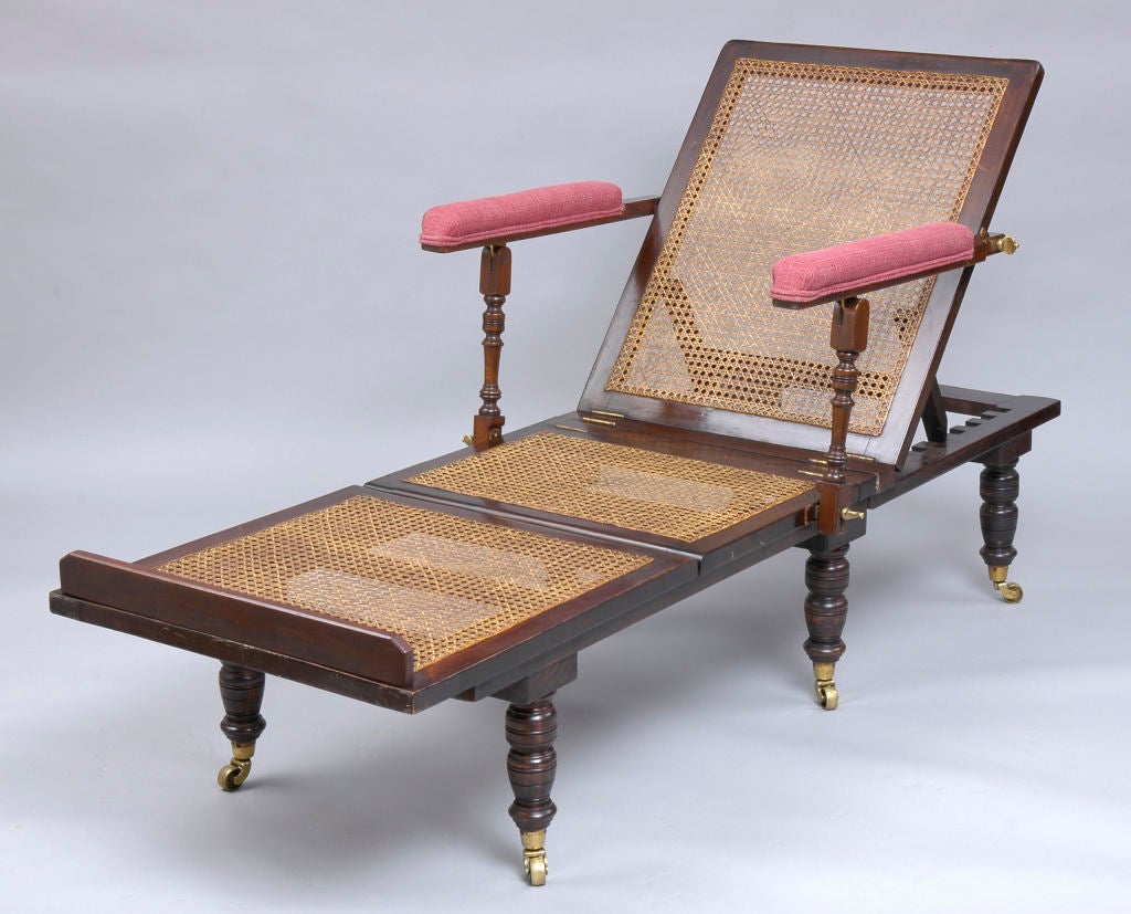 Victorian mahogany-stained beech campaign style day bed with removable arms and legs and caned seat with three cushions.  It is ratcheted on all three sections to adjust to numerous positions including flat.  The ivorine plaque states the maker:
