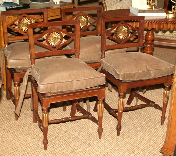 Circa 1725<br />
Rare set of 4 chairs composed of fruitwood featuring parcel gilt starbust detail with pierced back splat with pieced back splat detail and spooled leg stretchers.