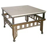 A French Art Deco Iron and Travertine Low Table.