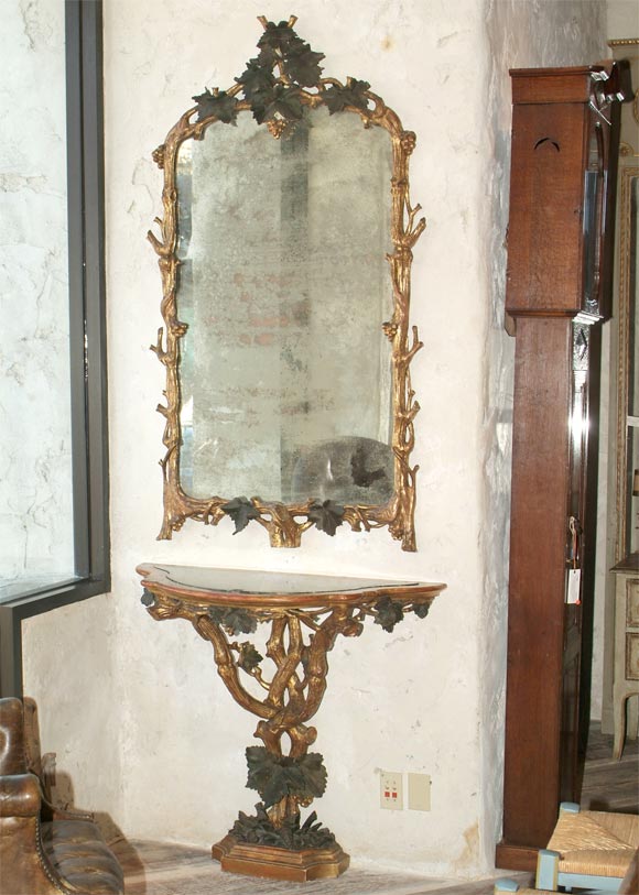19th century Italian console with green marble insert and matching mirror. Painted and parcel gilt carved wood.