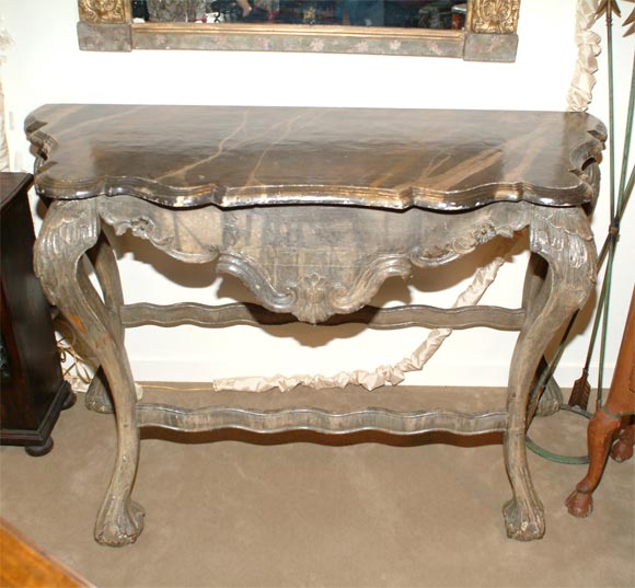 A rare and elegant Portuguese carved and painted wooden Console made during the last half of the Eighteenth Century.  This piece shows strong Italian style with classic Portugese interpretation.  The 