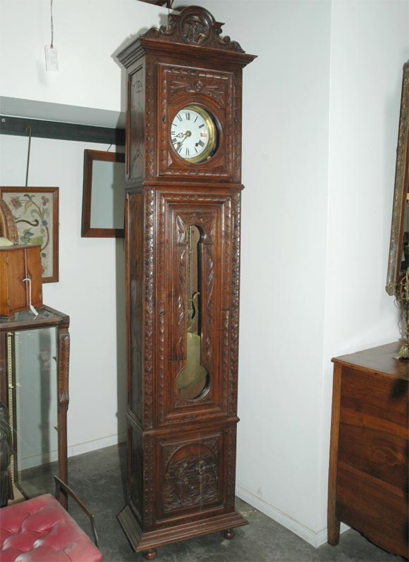 This 19th century grandfather clock is from the Brittany area of France and has stood the test of time very well. Standing about 8ft. tall the clock features a key wound eight day movement driven by two iron weights. The clock strikes the hour and