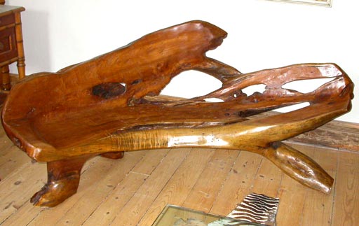 Uniquely carved and polished tree trunk bench.